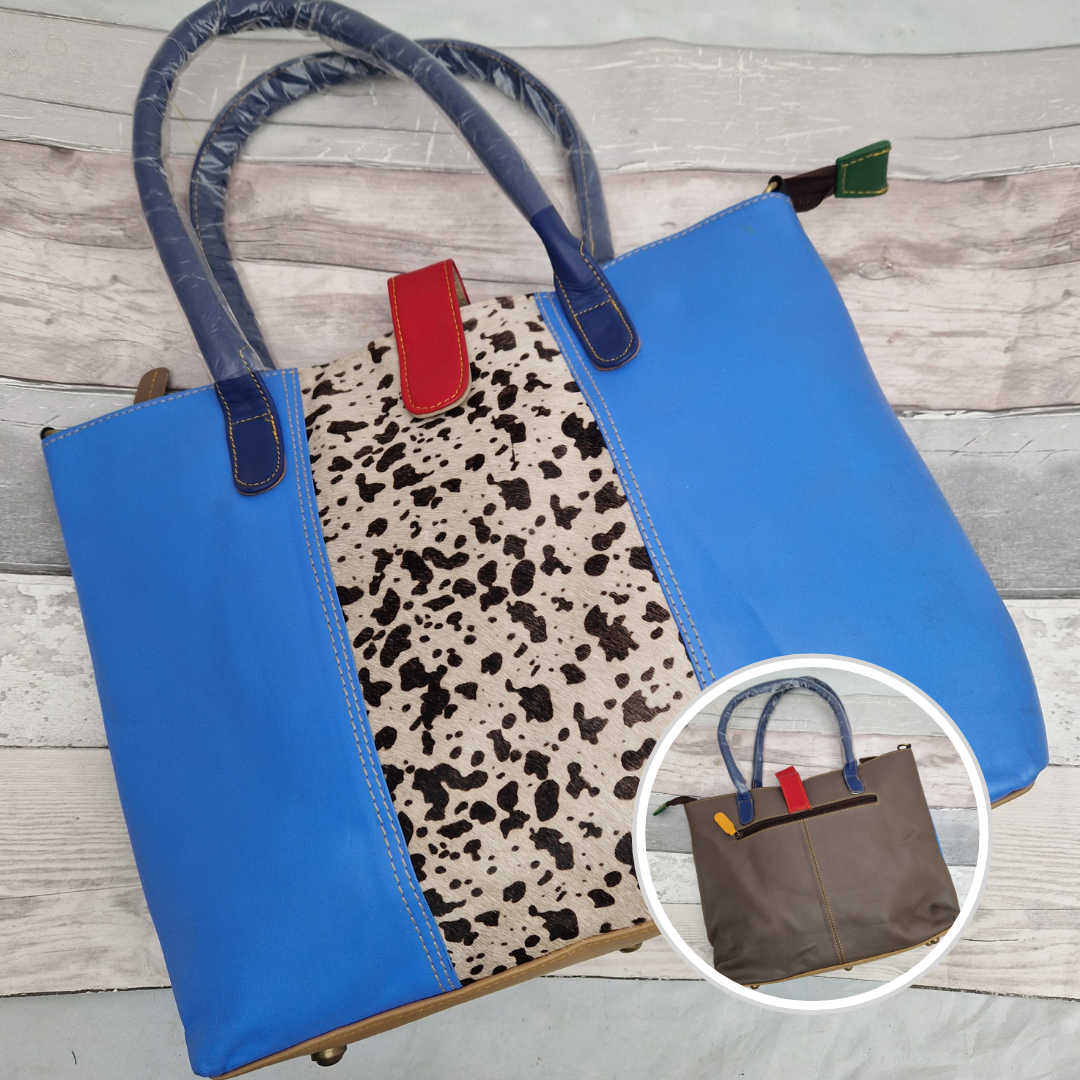 All leather tote bag in bright blue with a textured panel of cow hide print running down the centre.