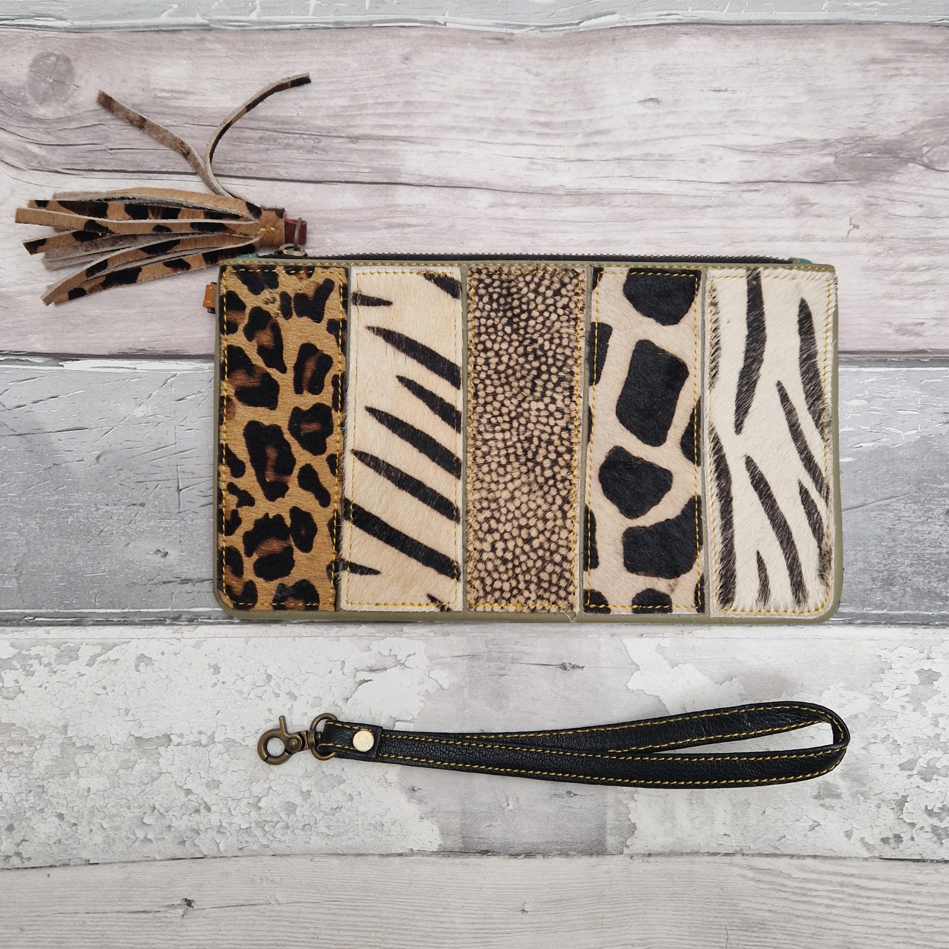 All leather animal print bag with detachable wrist strap.