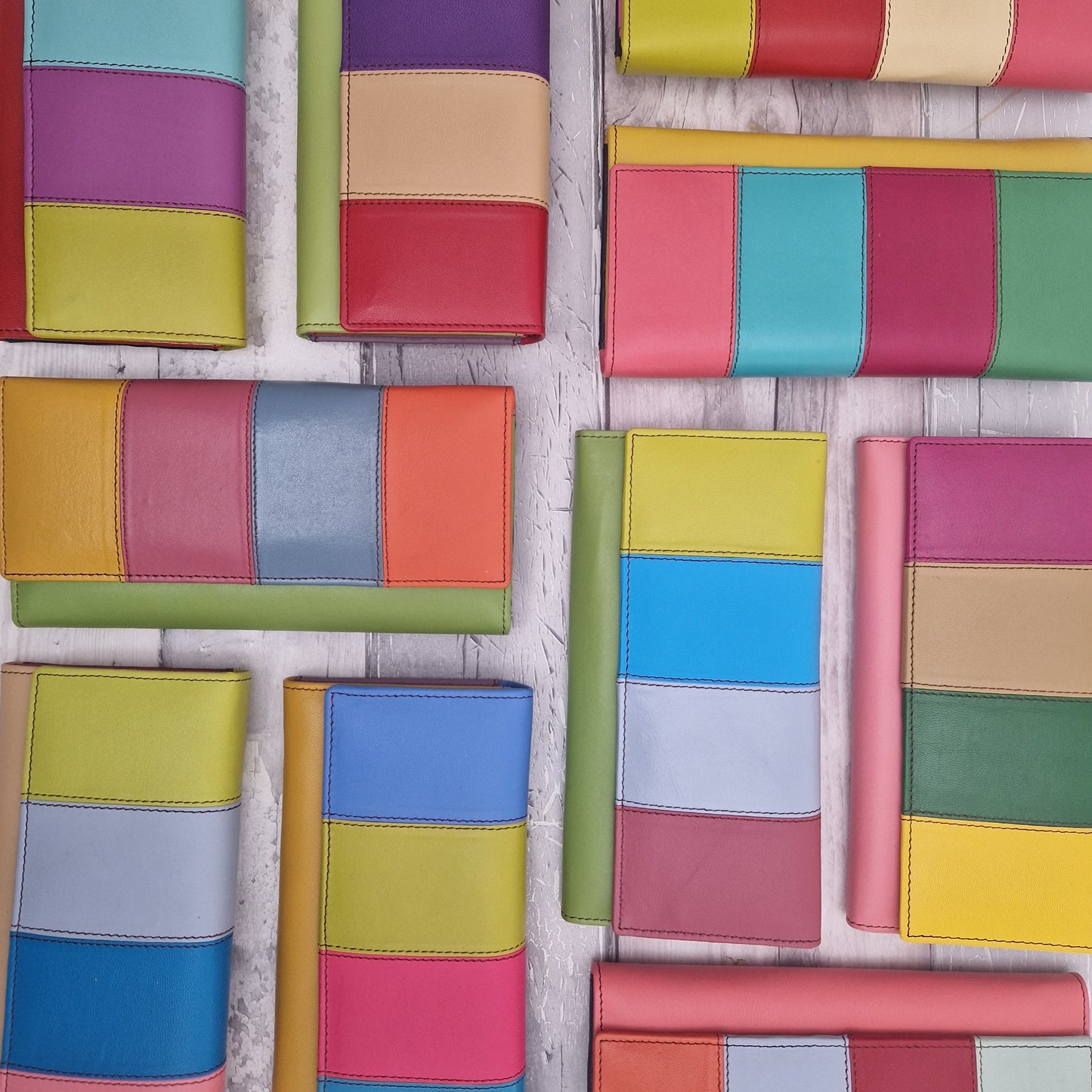 Photo of Sassy Spirit Eva style purses laid out flat showing off their rainbow colours.