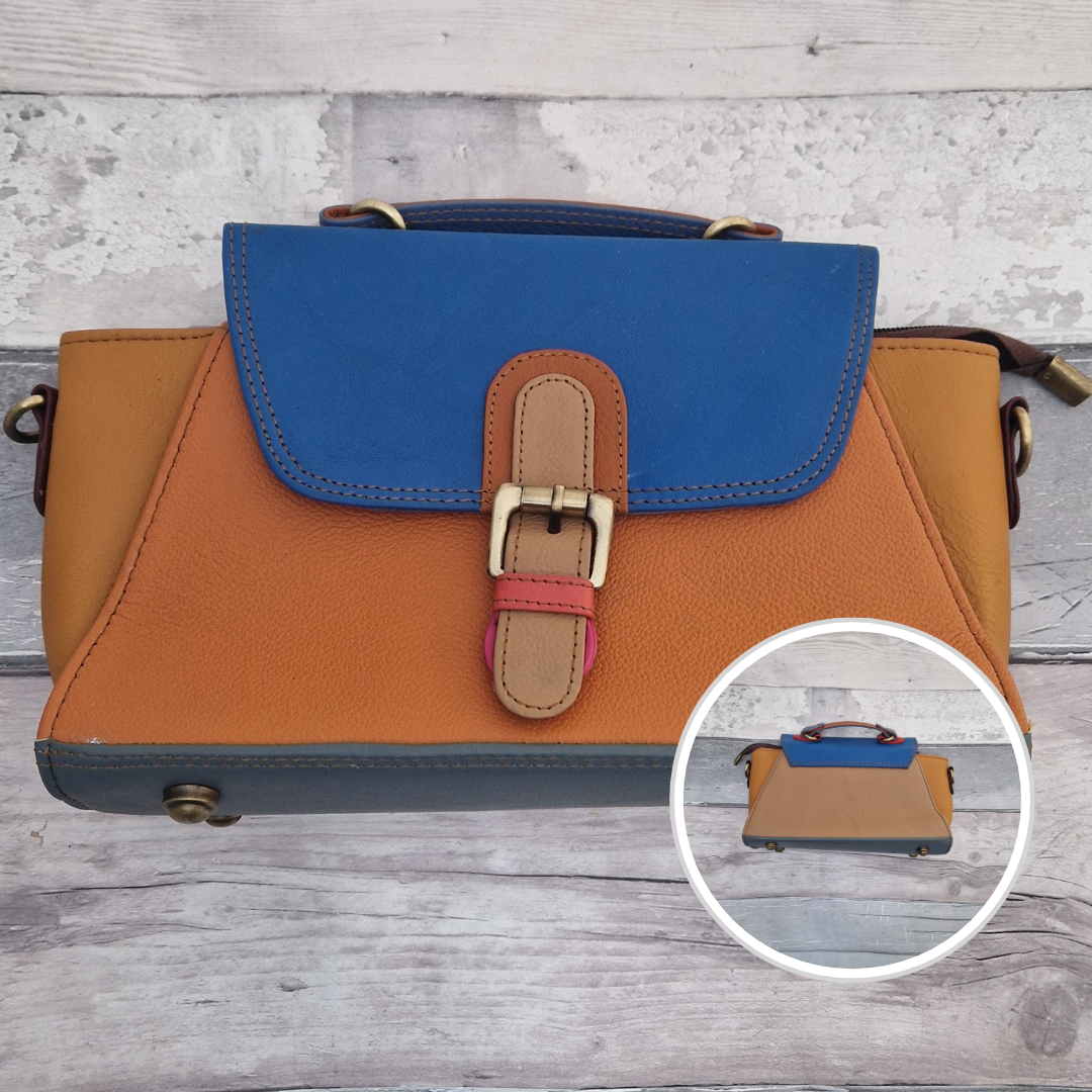 Jhansi style bag is a mini satchel with a top carry handle and a detachable cross body strap. Made from leather off-cuts she is a mix of colours, predominantly tan, mustard and royal blue.