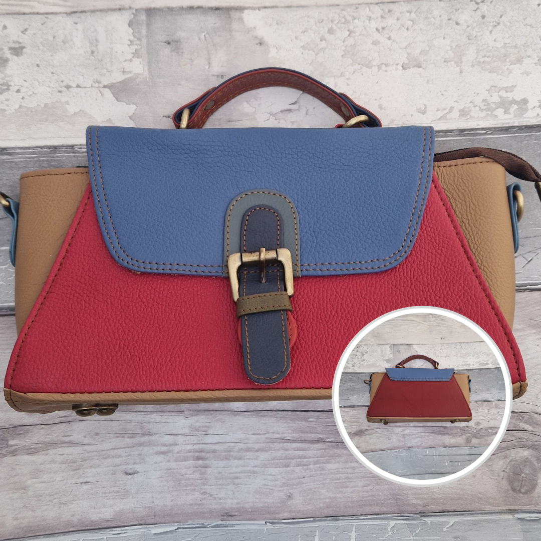 Jhansi style bag is a mini satchel with a top carry handle and a detachable cross body strap. Made from leather off-cuts she is a mix of colours, predominantly tan, red and blue.