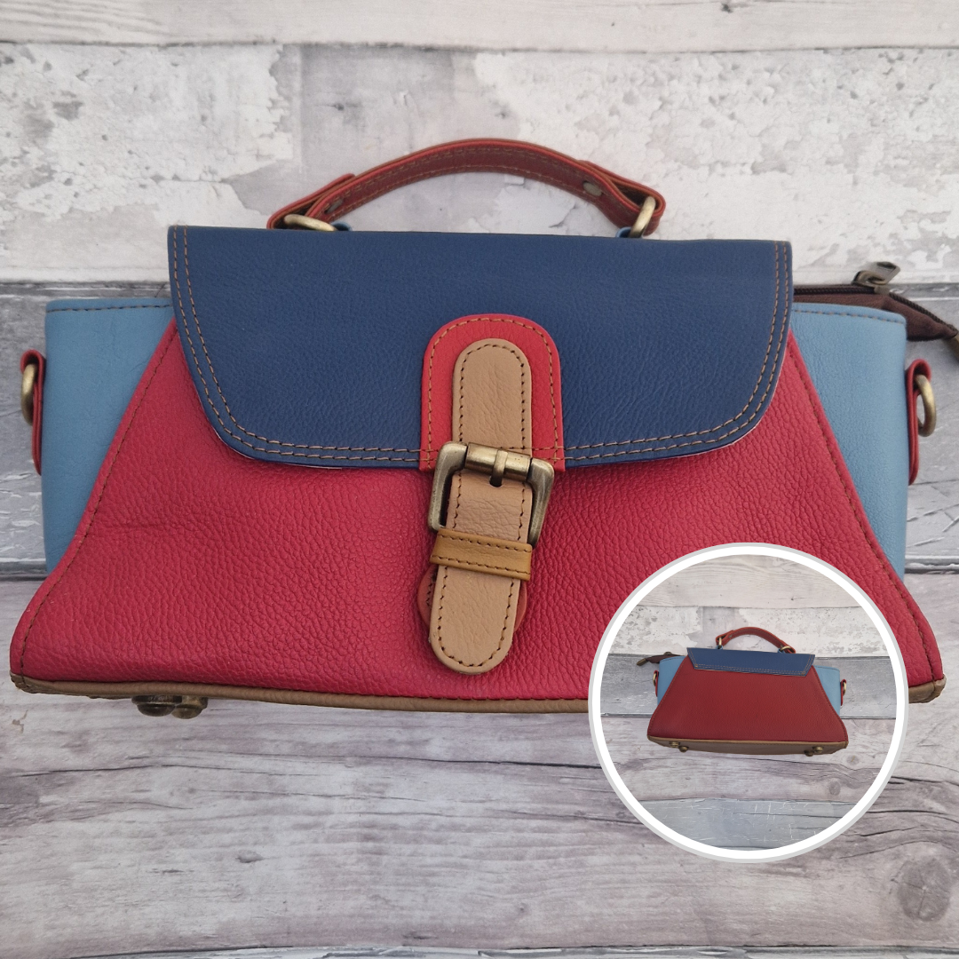 Jhansi style bag is a mini satchel with a top carry handle and a detachable cross body strap. Made from leather off-cuts she is a mix of colours, predominantly red, blue and navy.