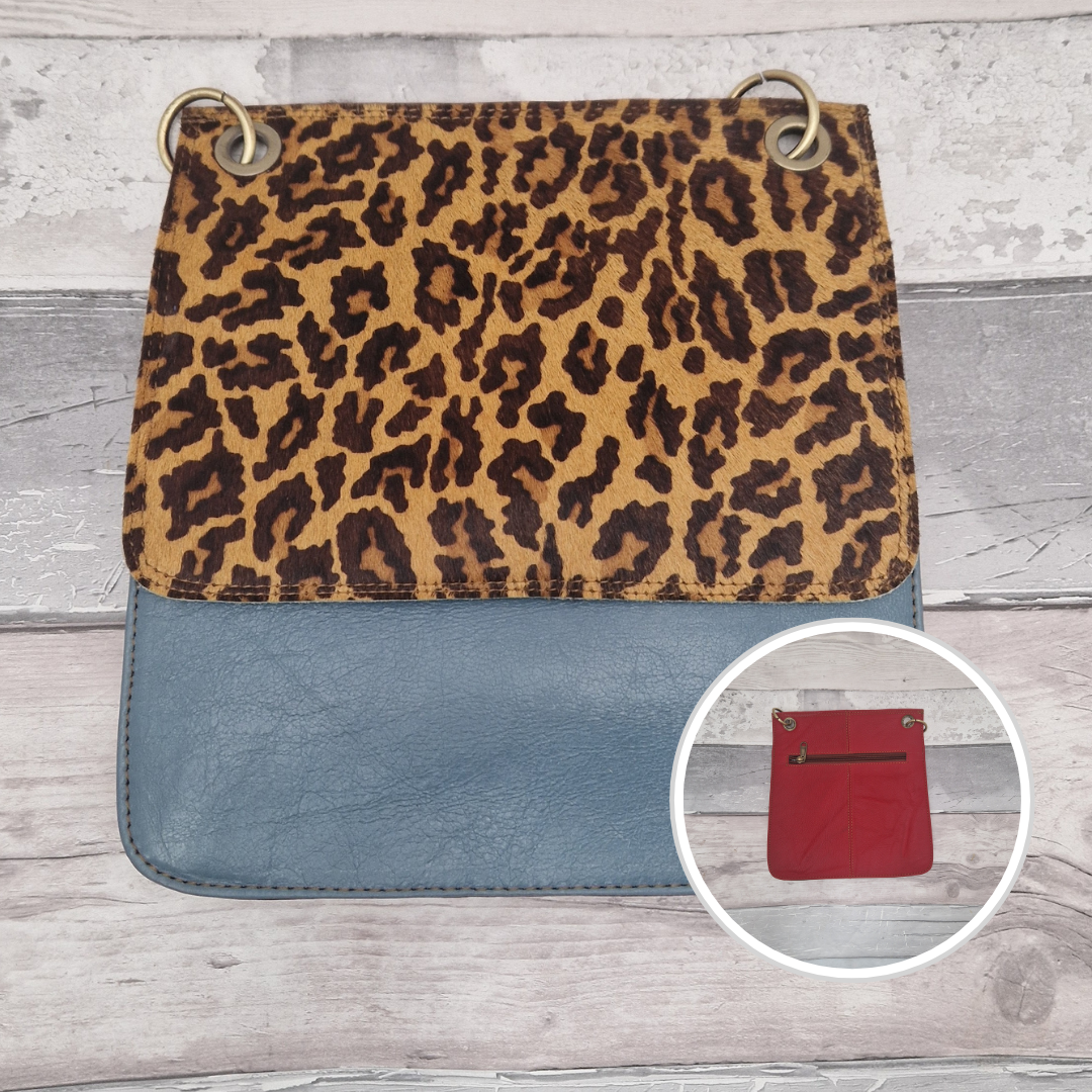 All leather modern messenger style bag with a stone blue panel and textured Jaguar print panel.