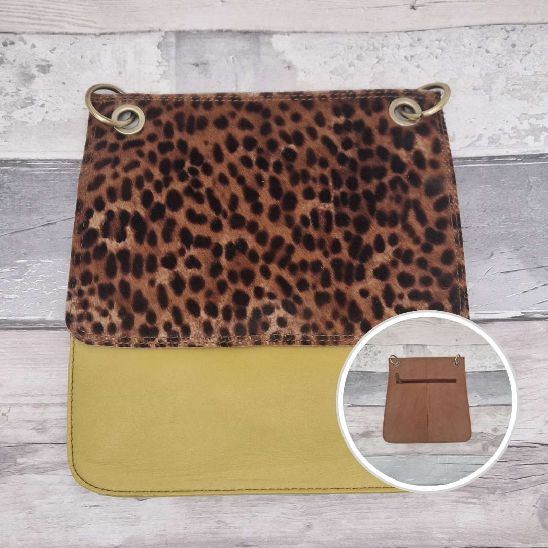 All leather modern messenger style bag with a mustard panel and textured wild spot print panel.