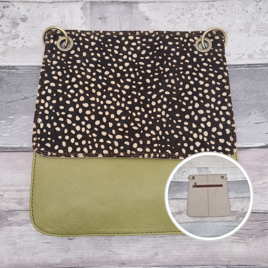 All leather modern messenger style bag with a lime green panel and textured dark spot print panel.