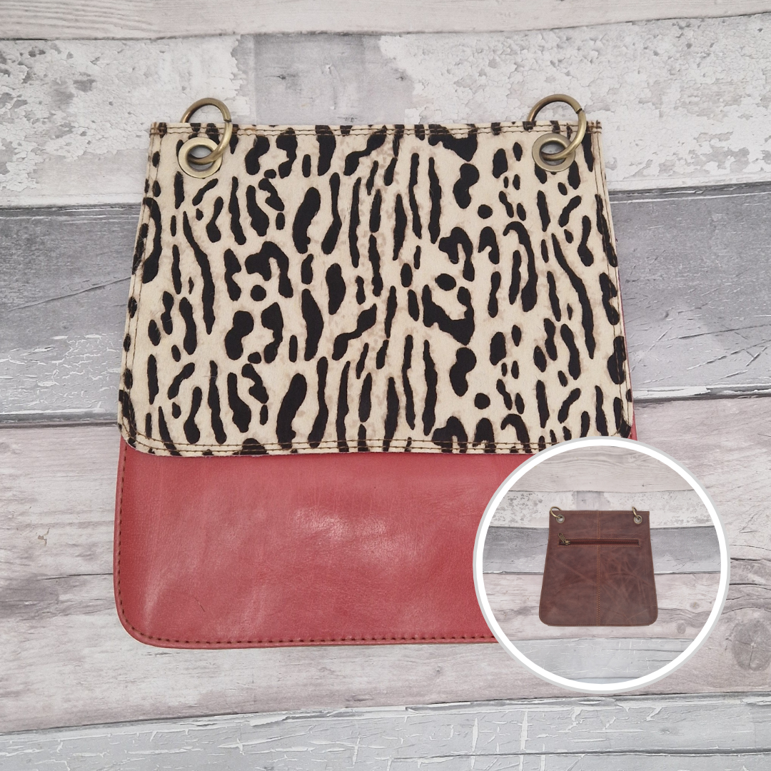 All leather modern messenger style bag with a red panel and textured ocelot print panel.