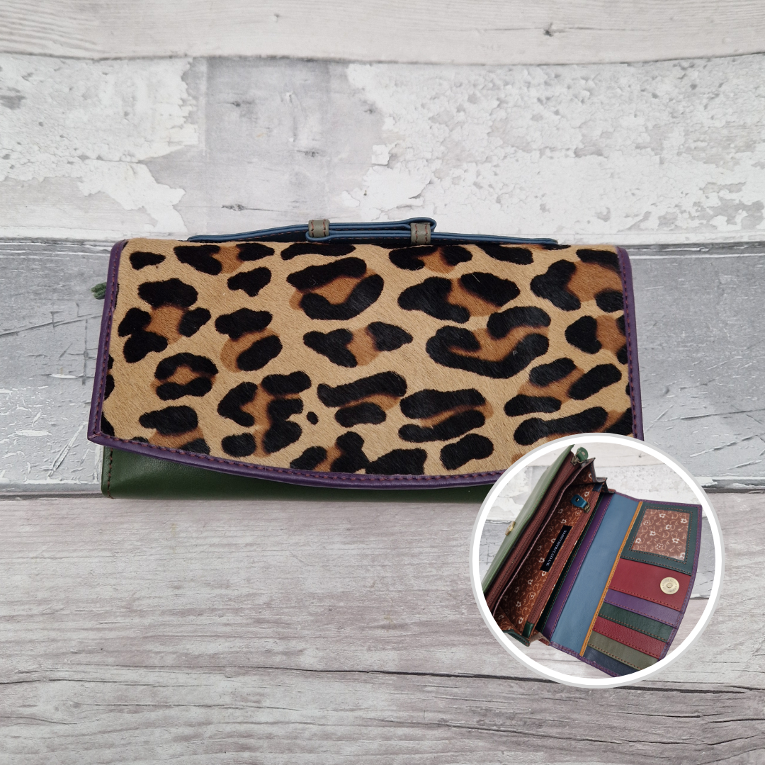 All leather purse with a green and purple coloured exterior and textured panel of leopard print.