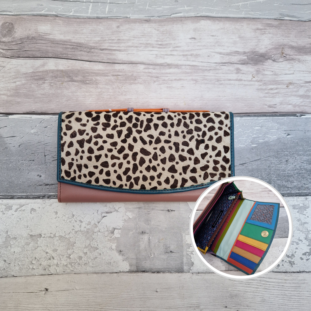 All leather purse with a pink and blue coloured exterior and textured panel of Iberian Lynx print.