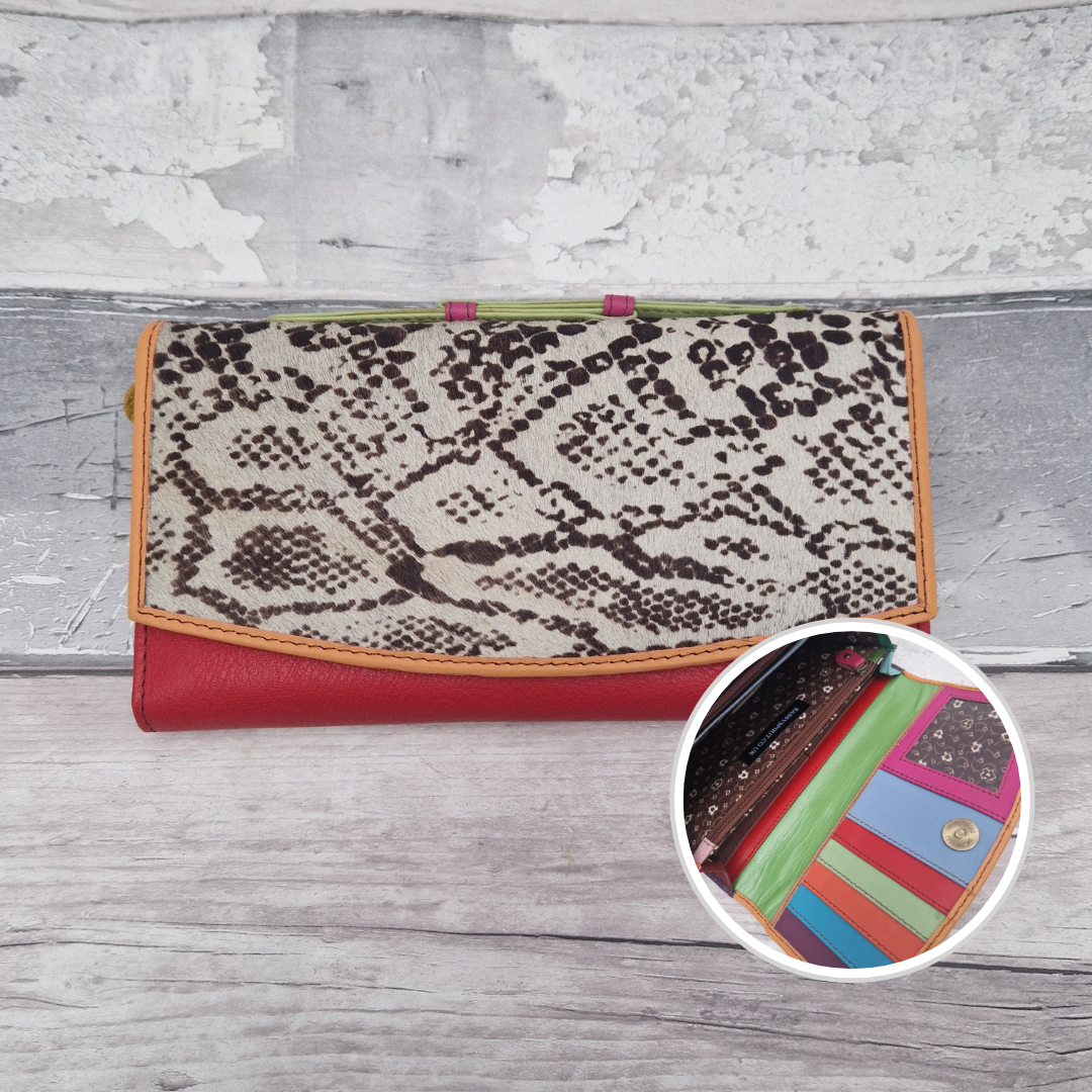 All leather purse with a orange and red coloured exterior and textured panel of snake skin print.