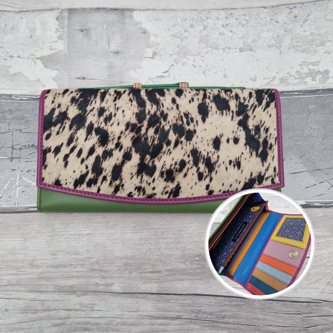 All leather purse with a green and pink coloured exterior and textured panel of pony print.