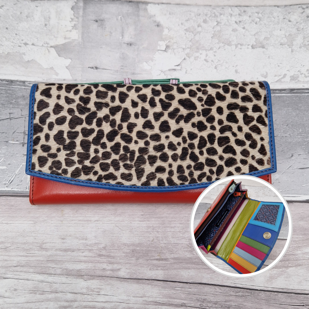 All leather purse with a red and blue coloured exterior and textured panel of lynx print.