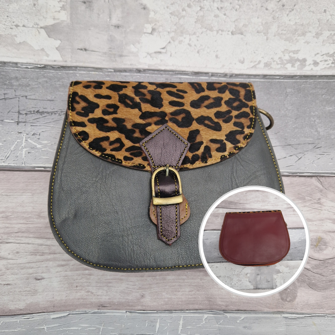 Leather saddlebag shaped bag with a grey front and a textured panel of Jaguar print.