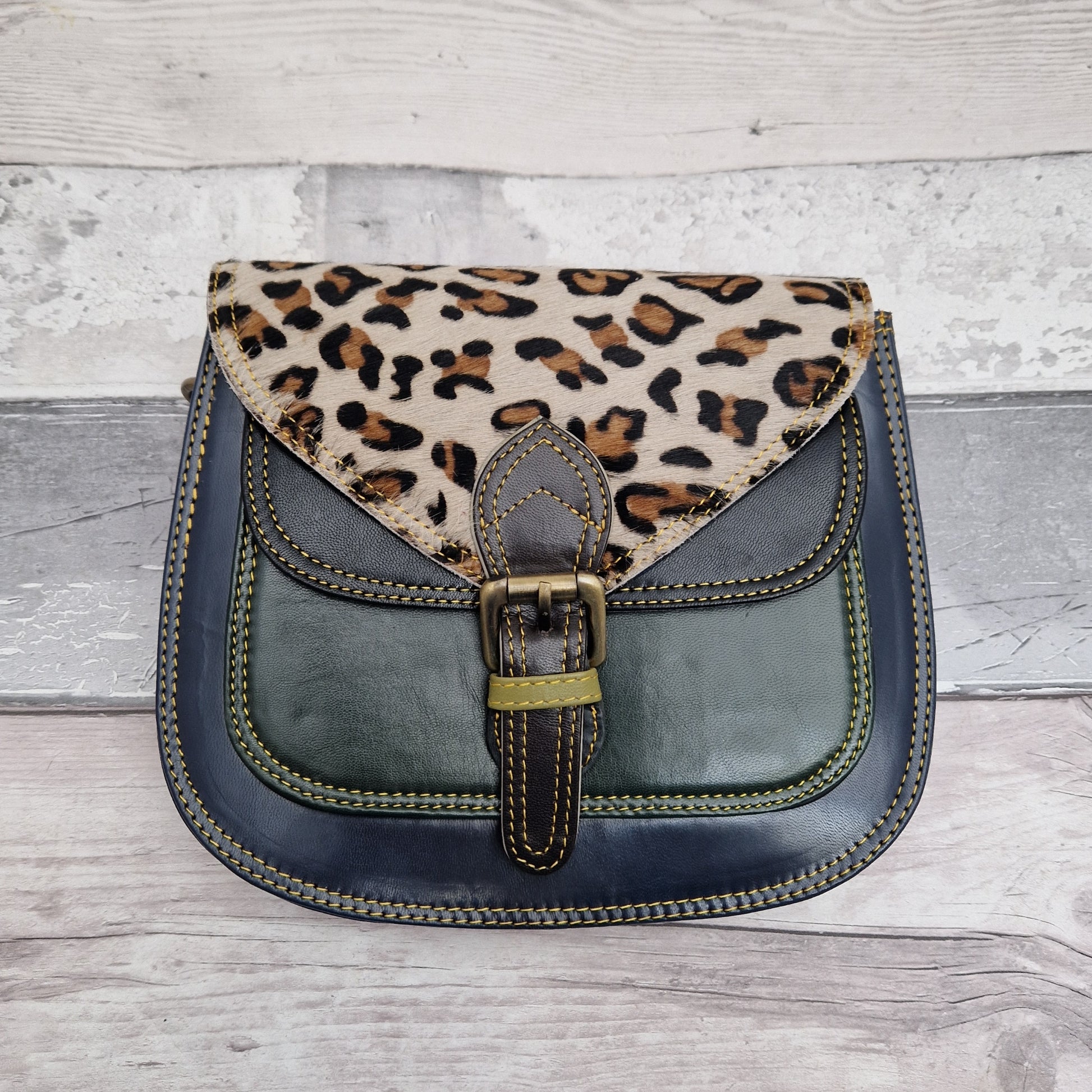 Saddlebag style bag in navy leather with contrasting colour panels and a section of textured Leopard Print