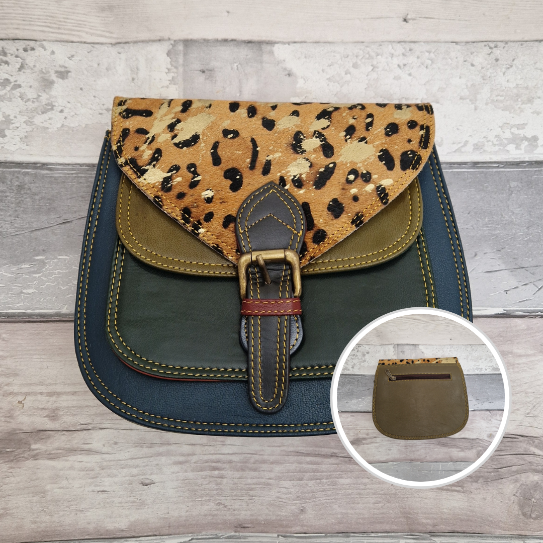 Saddlebag style bag in navy leather with contrasting colour panels and a section of metallic gold leopard print.