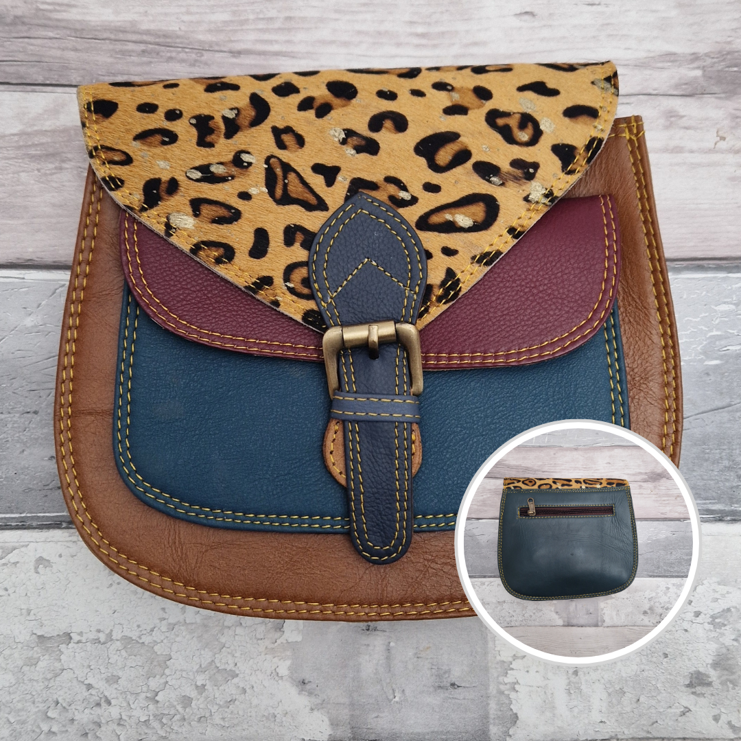 Saddlebag style bag in brown leather with contrasting coloured panels and a section of textured metallic leopard print