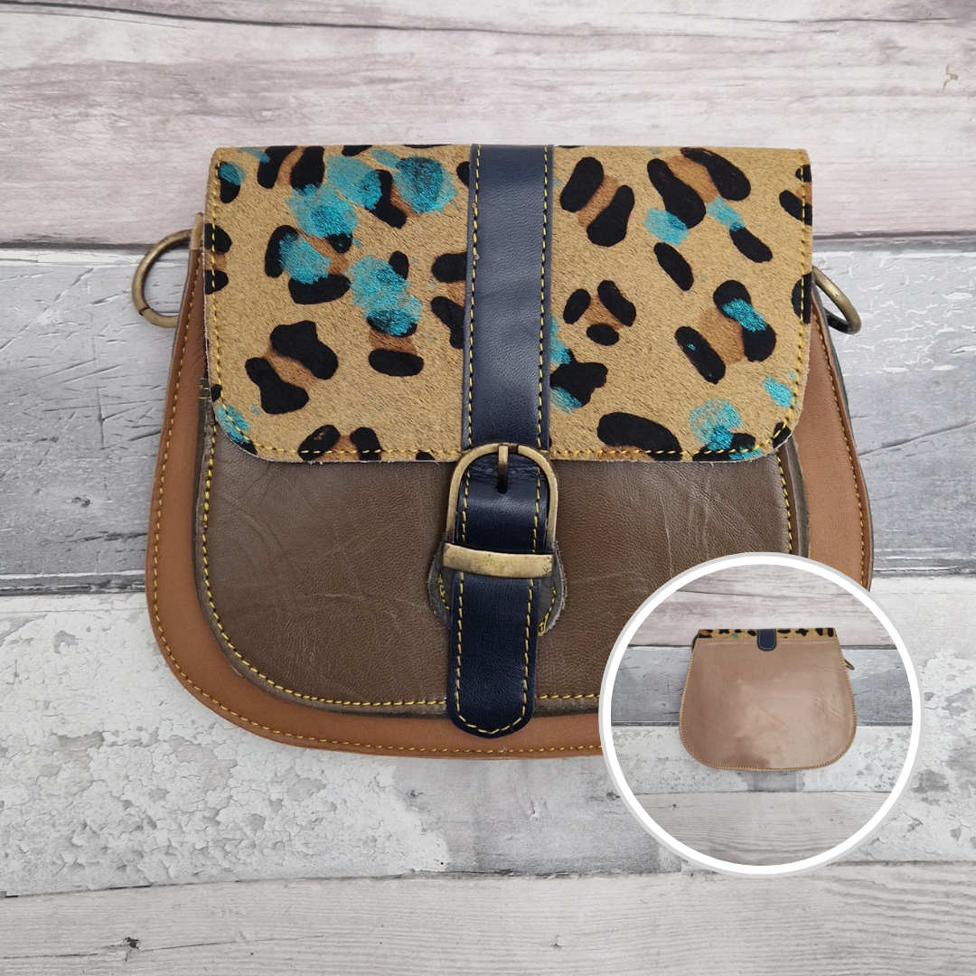 All leather saddlebag style ladies bag in 2 tones of brown and with a textured panel of leopard print splattered with metallic blue splashes. Brass buckle closer.