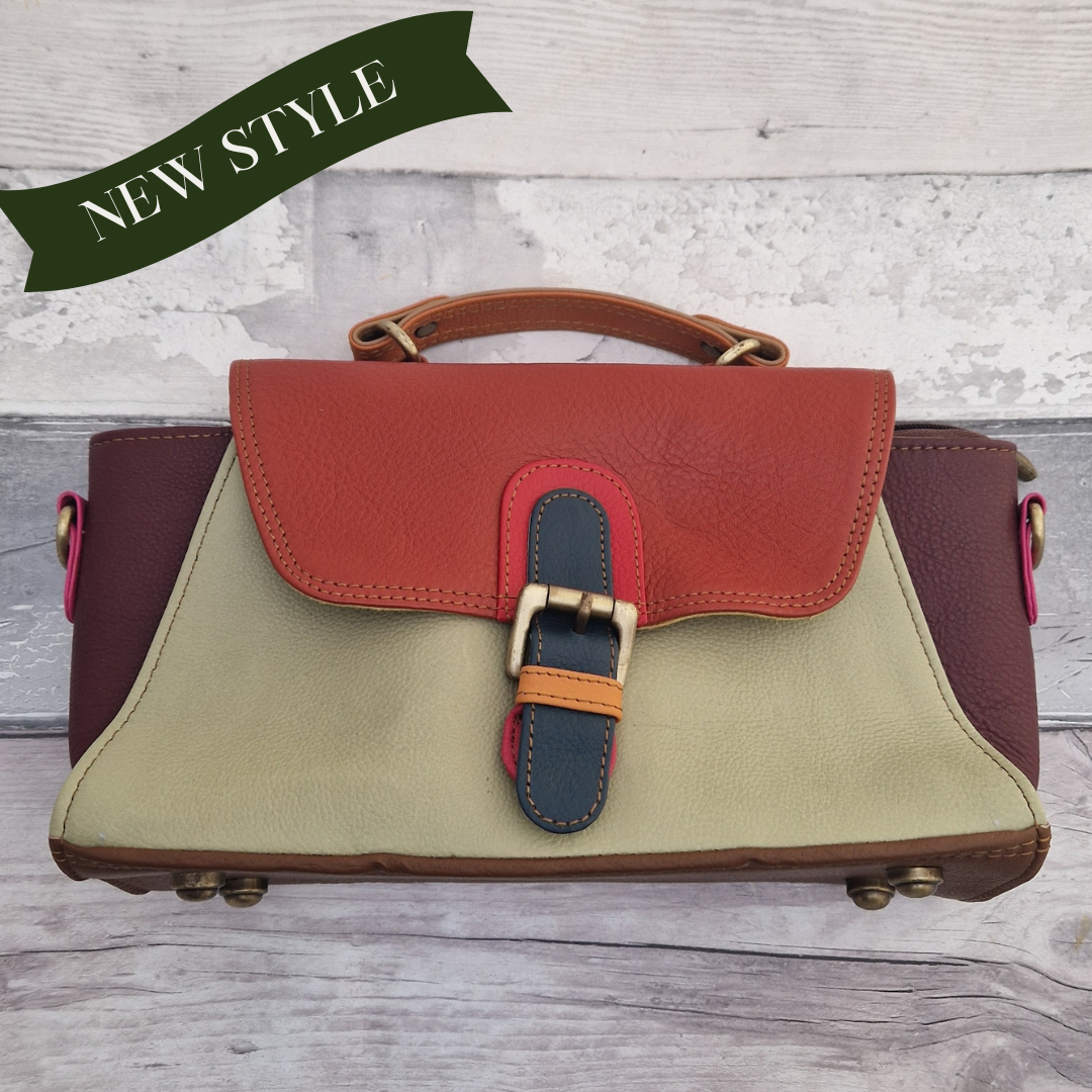 Jhansi style bag is a mini satchel with a top carry handle and a detachable cross body strap. Made from leather off-cuts she is a mix of colours, predominantly brown, rust and lime cream.