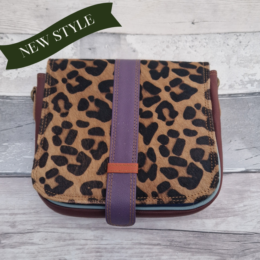 Zoya is a Messenger style bag with a tab on the front to lift for access. She is made from leather off-cuts and is presented in a multitude of colours finished with a large front panel in textured leopard animal print.