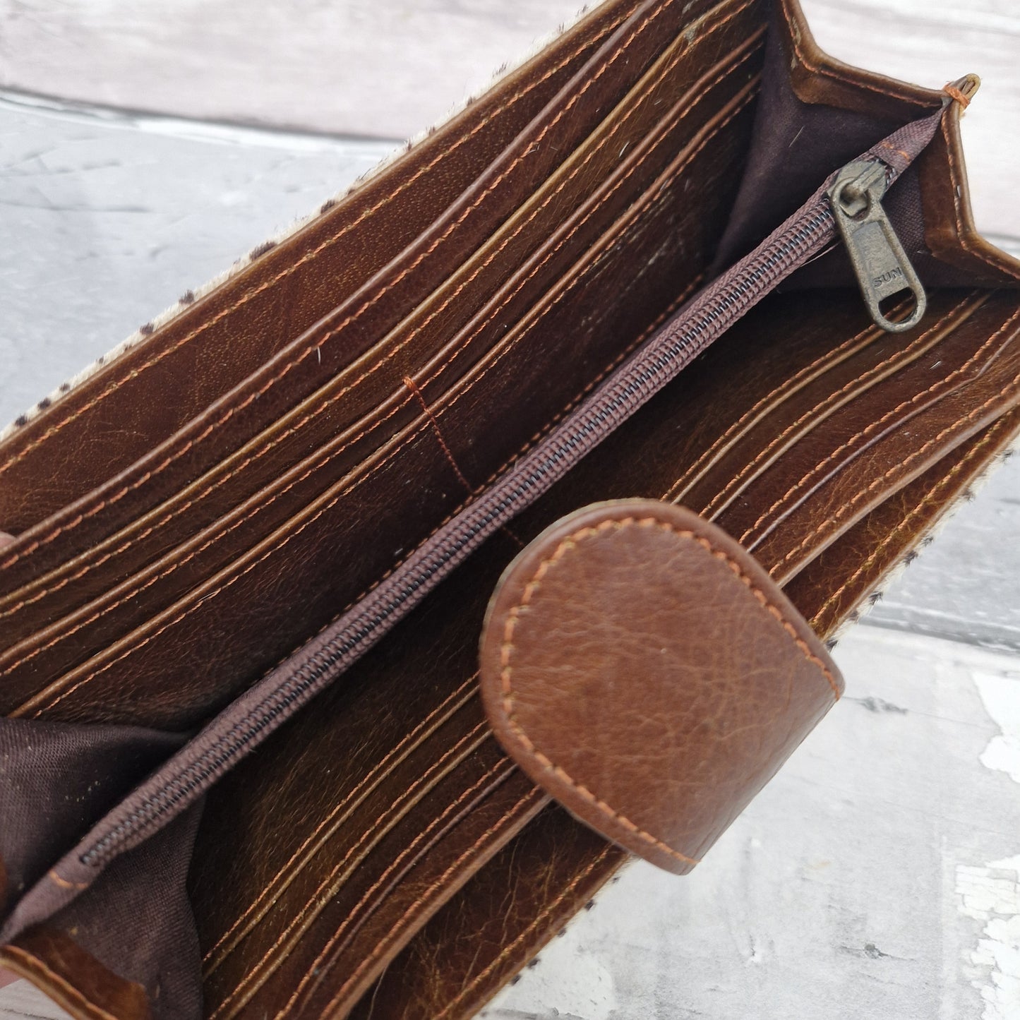 Inside view of Nidhi style leather purse showing all card slots and compartments.