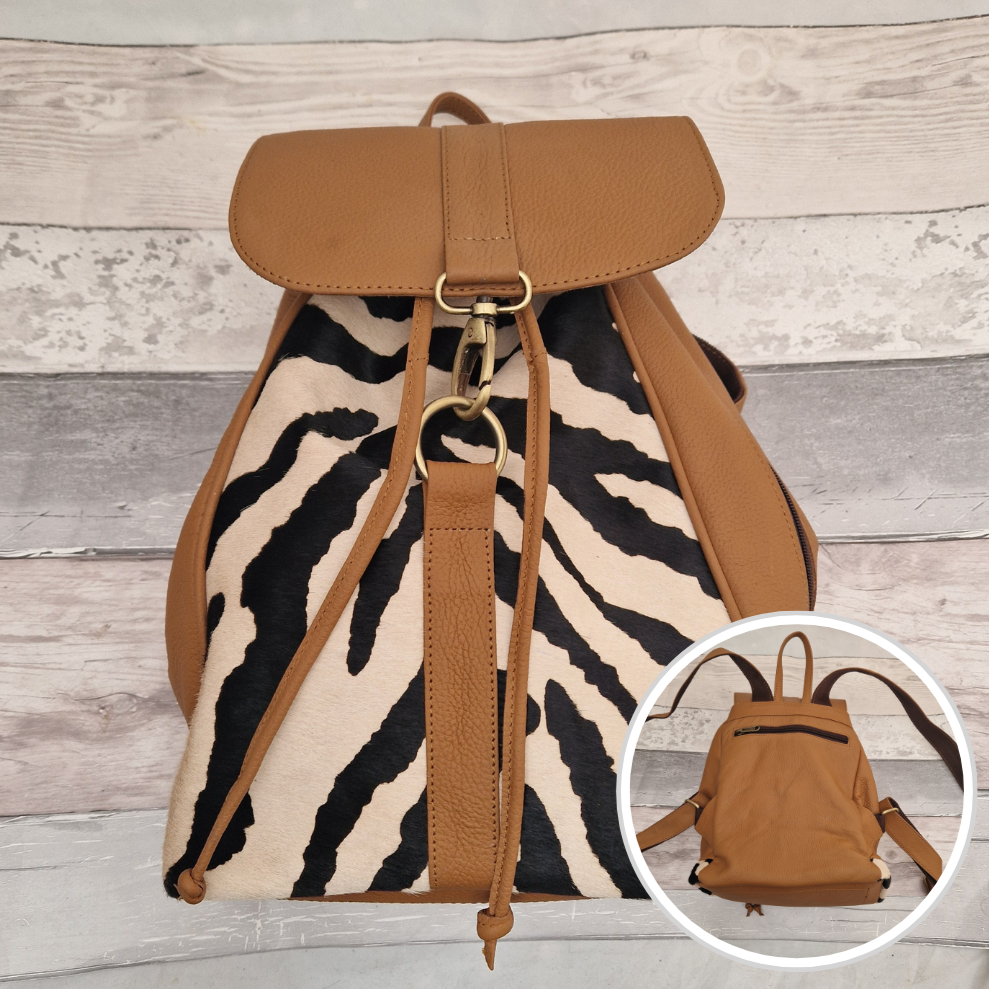 Tan leather back pack with textured panels of black and white zebra print.