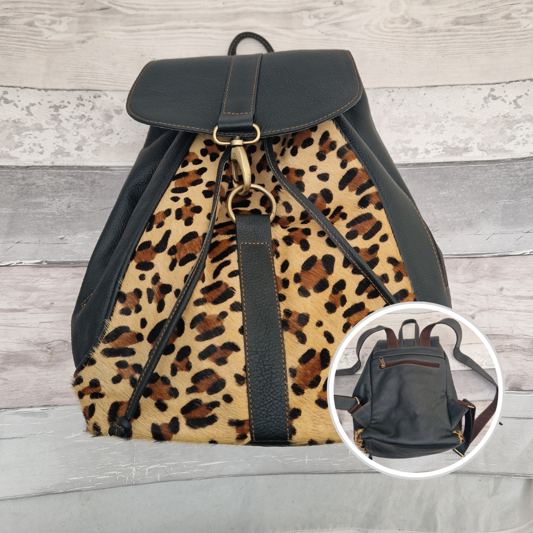 Forest Green leather back pack with textured panels of leopard print.