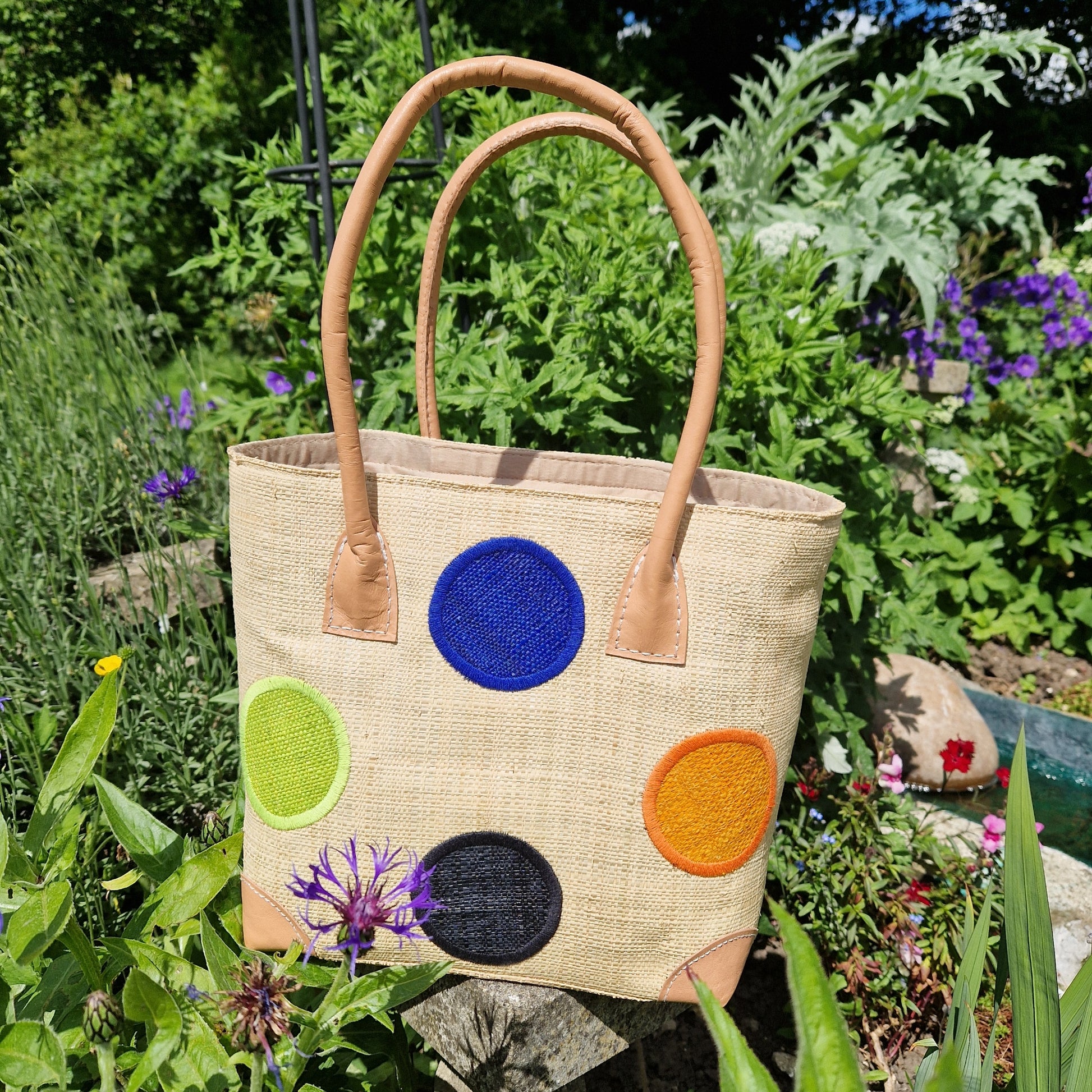 Natural Raffia Baskets with coloured spot pattern.