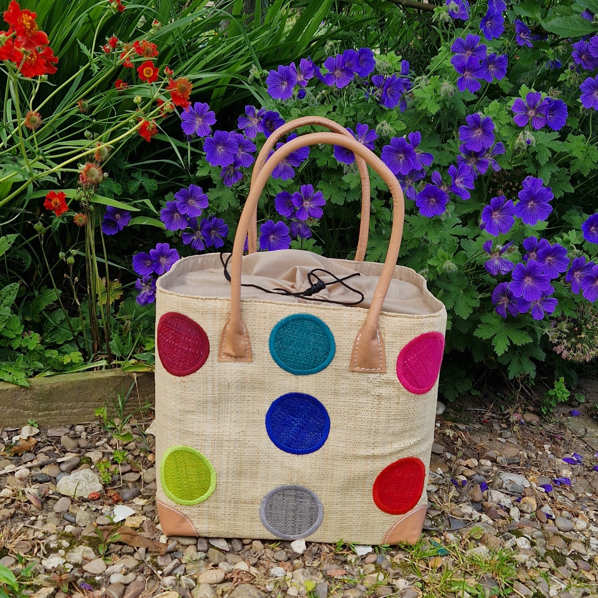 Natural Raffia Baskets with coloured spot pattern.