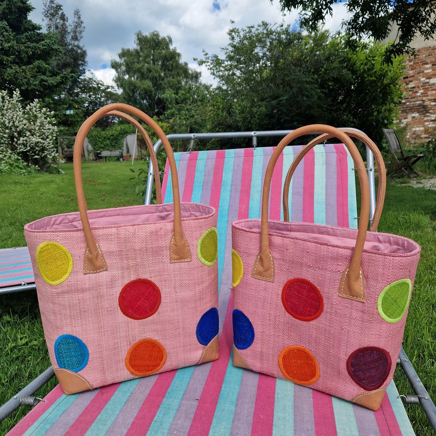 Raffia Baskets in Baby Pink decorated with rainbow coloured spots.