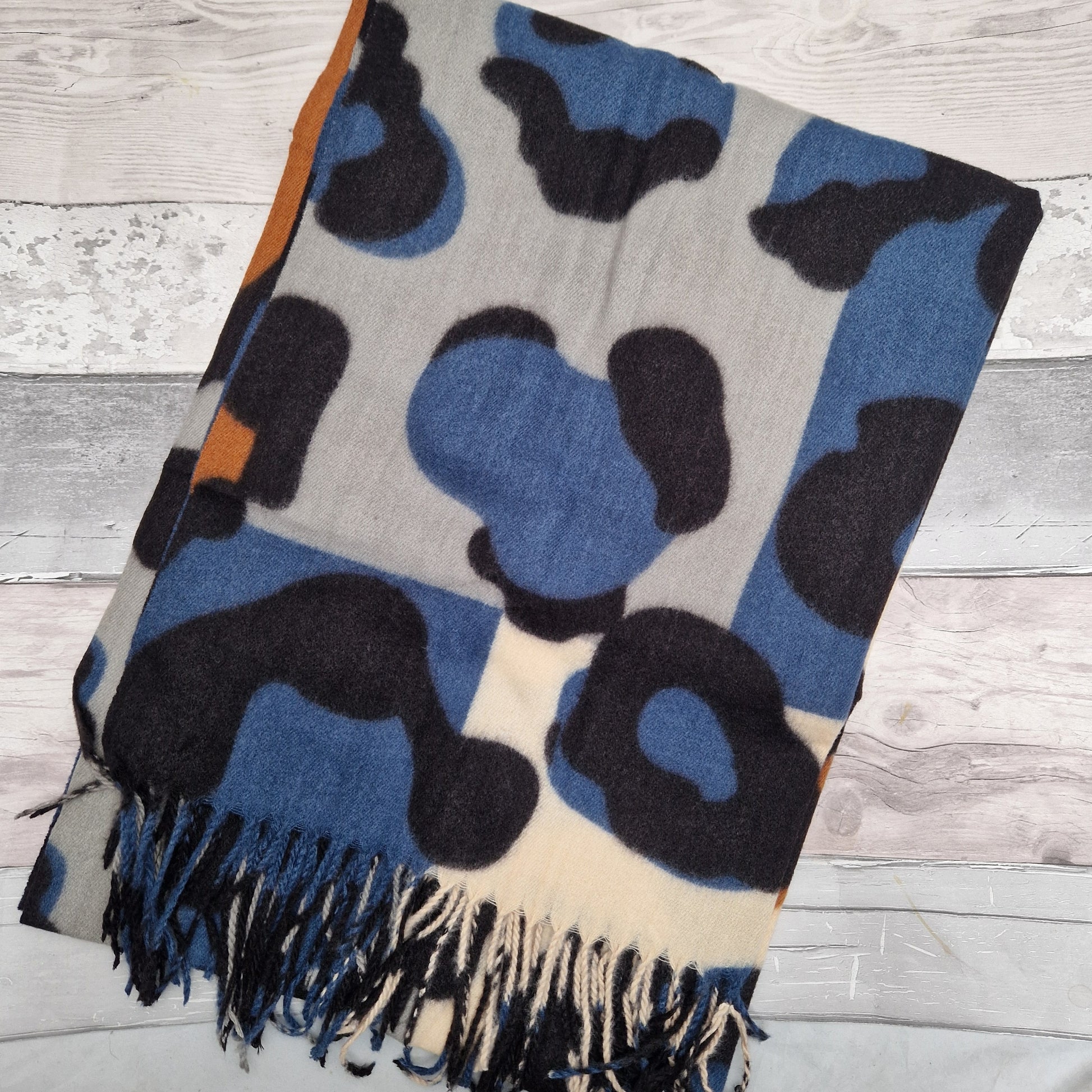 Abstract leopard print scarf in blue, black, grey and cream tones.