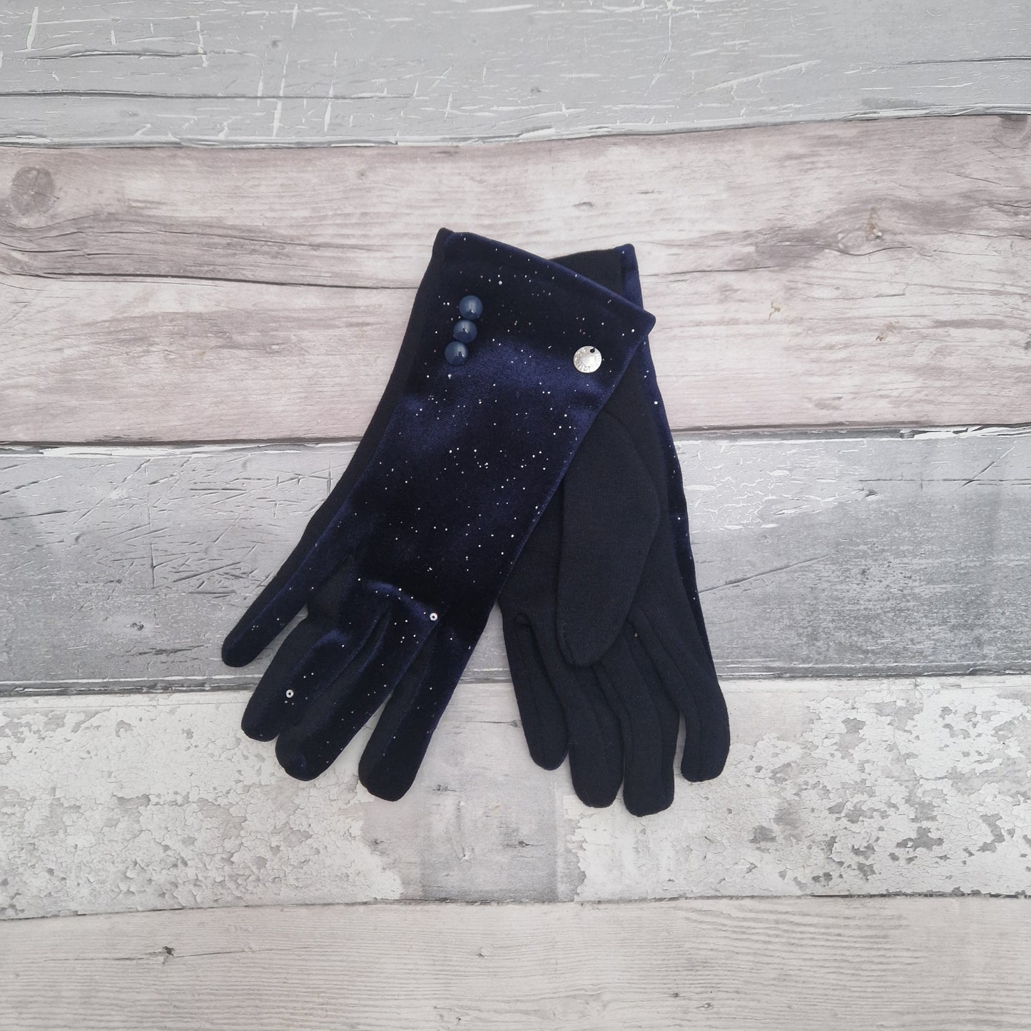 Navy velvet ladies gloves covered in a subtle silver sparkle. 3 Button Cuff detail.