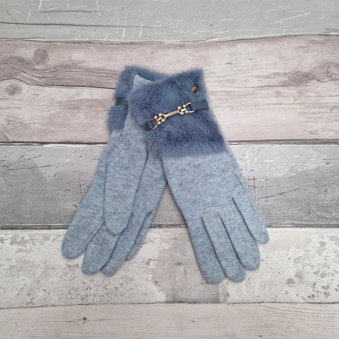 Power blue coloured ladies stretch gloves with a large faux fur cuff finished in a gold coloured bar buckle detail.