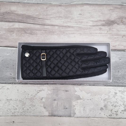 Black ladies gloves quilted with a strap and buckle detail. Gift Boxed.