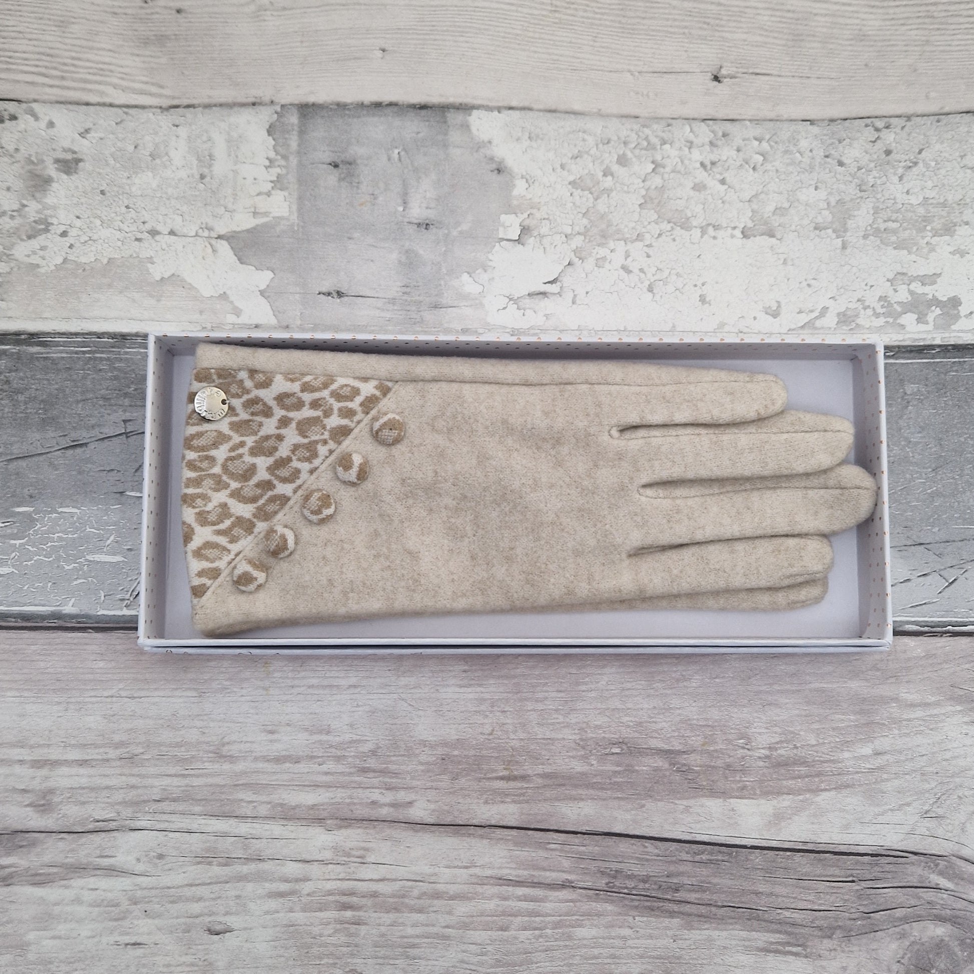 Cream coloured ladies gloves with a leopard print panel and matching buttons.