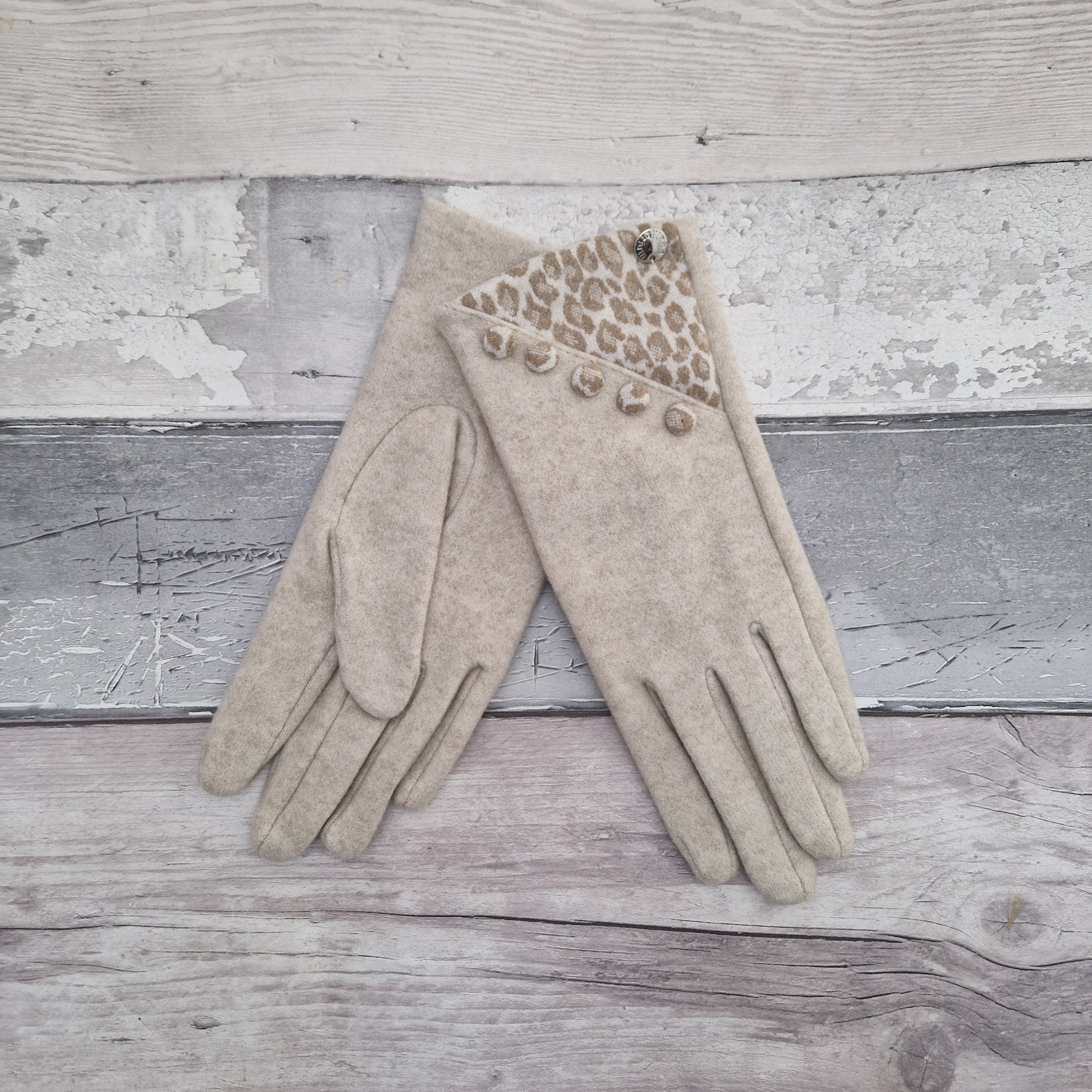 Cream coloured ladies gloves with a leopard print panel and matching buttons.