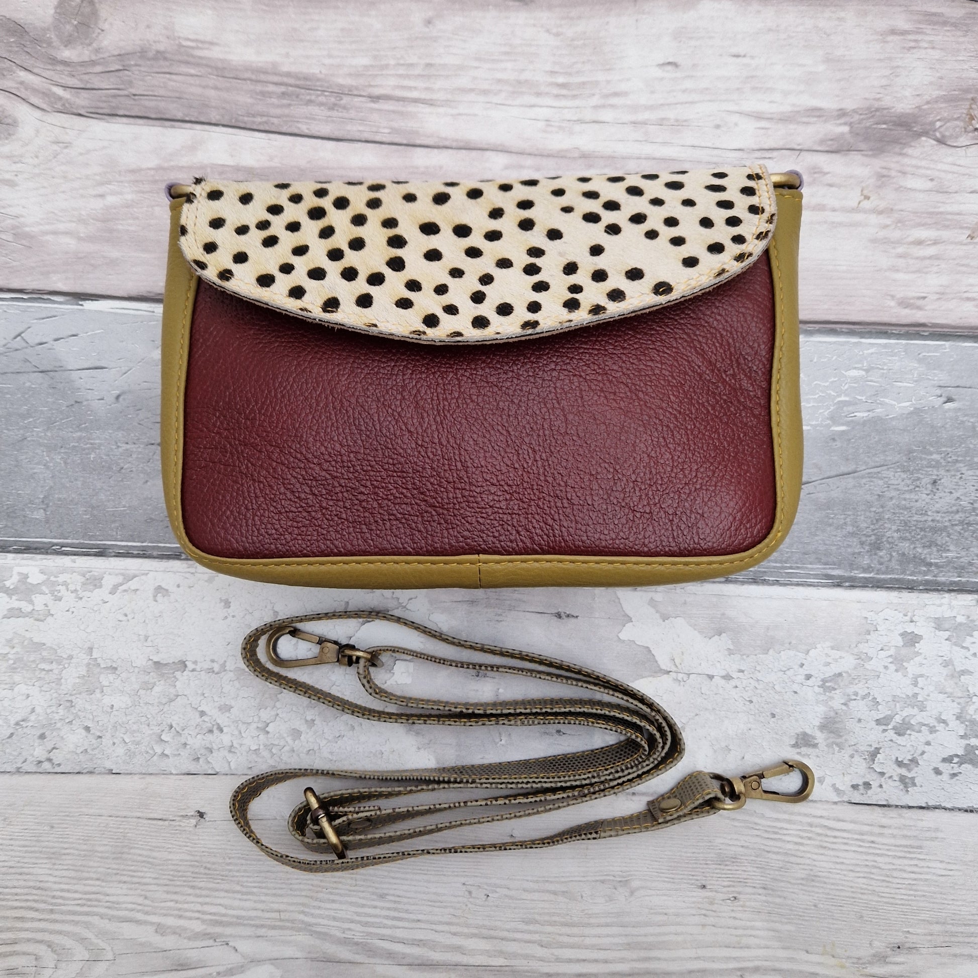 Leather crossbody bag in brown and mustard colours with a textured panel of black and white spot print.