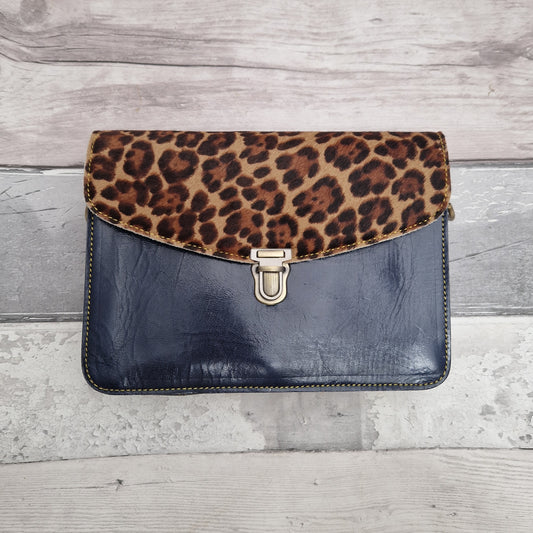 Navy Patent leather envelope style crossbody bag with a textured panel in brown Jaguar print.