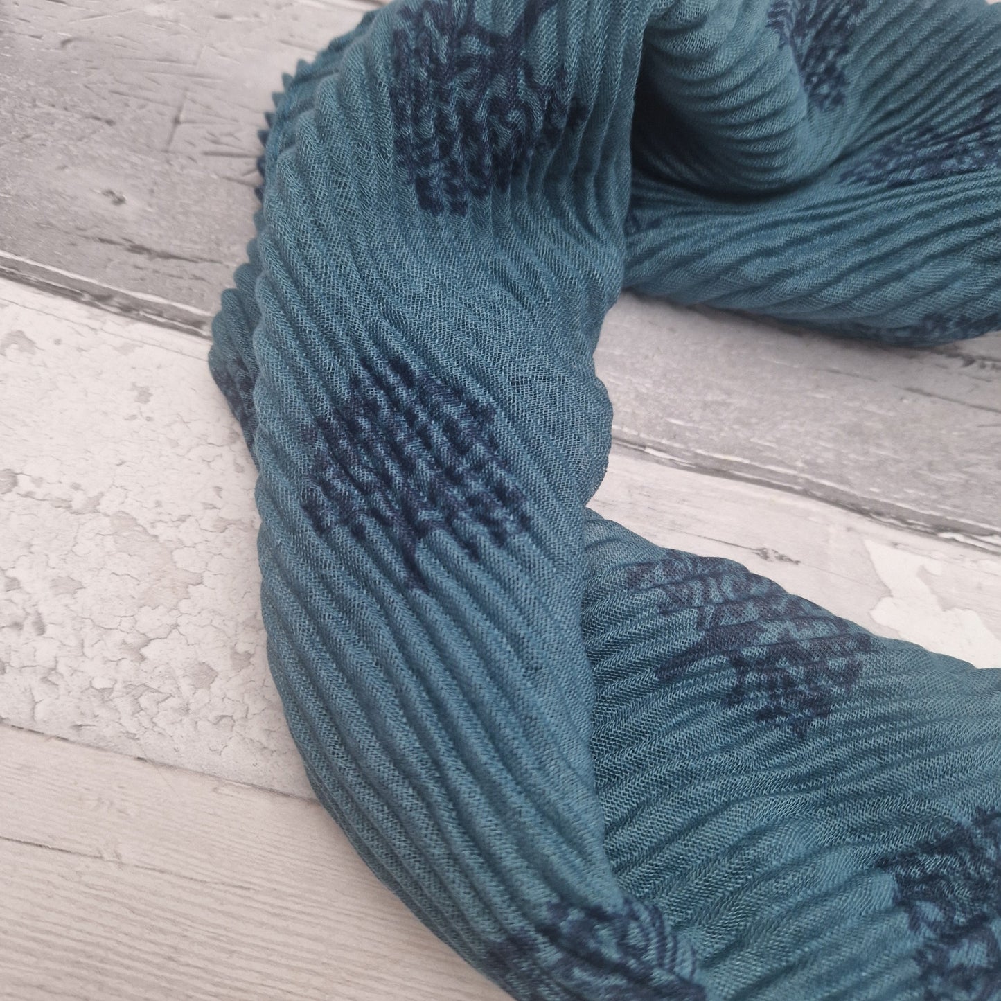 Turquoise coloured neck scarf with a tree of life print and silver magnetic closers.