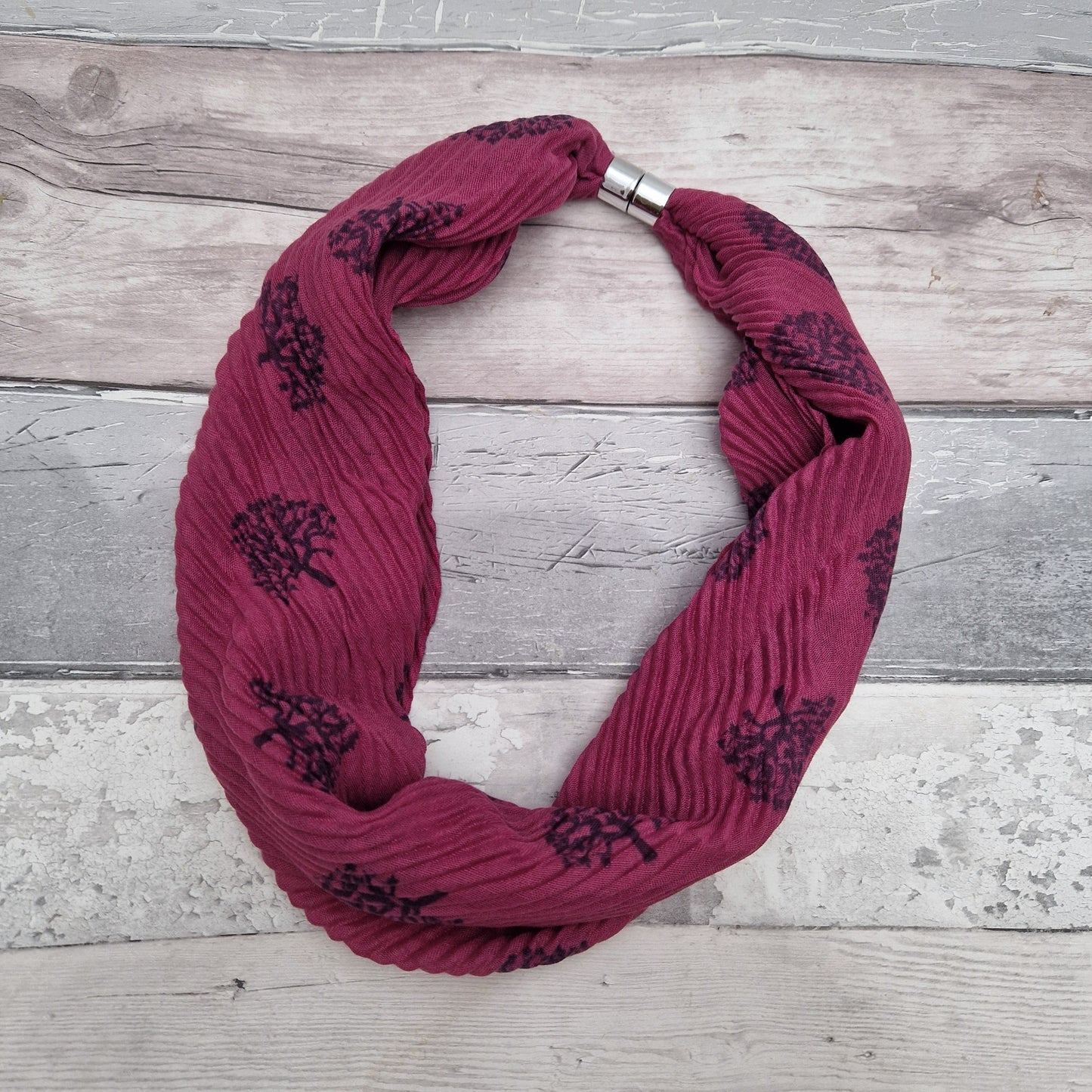 Magenta pink coloured neck scarf with a tree of life print and silver magnetic closers.