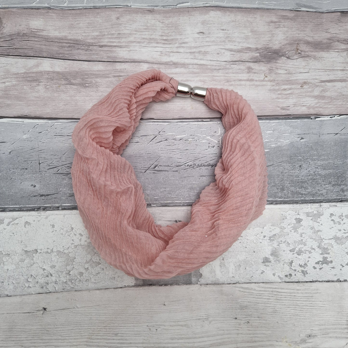 Pink coloured neck scarf with a crinkle texture and a fine silver sparkle and silver magnetic closers.