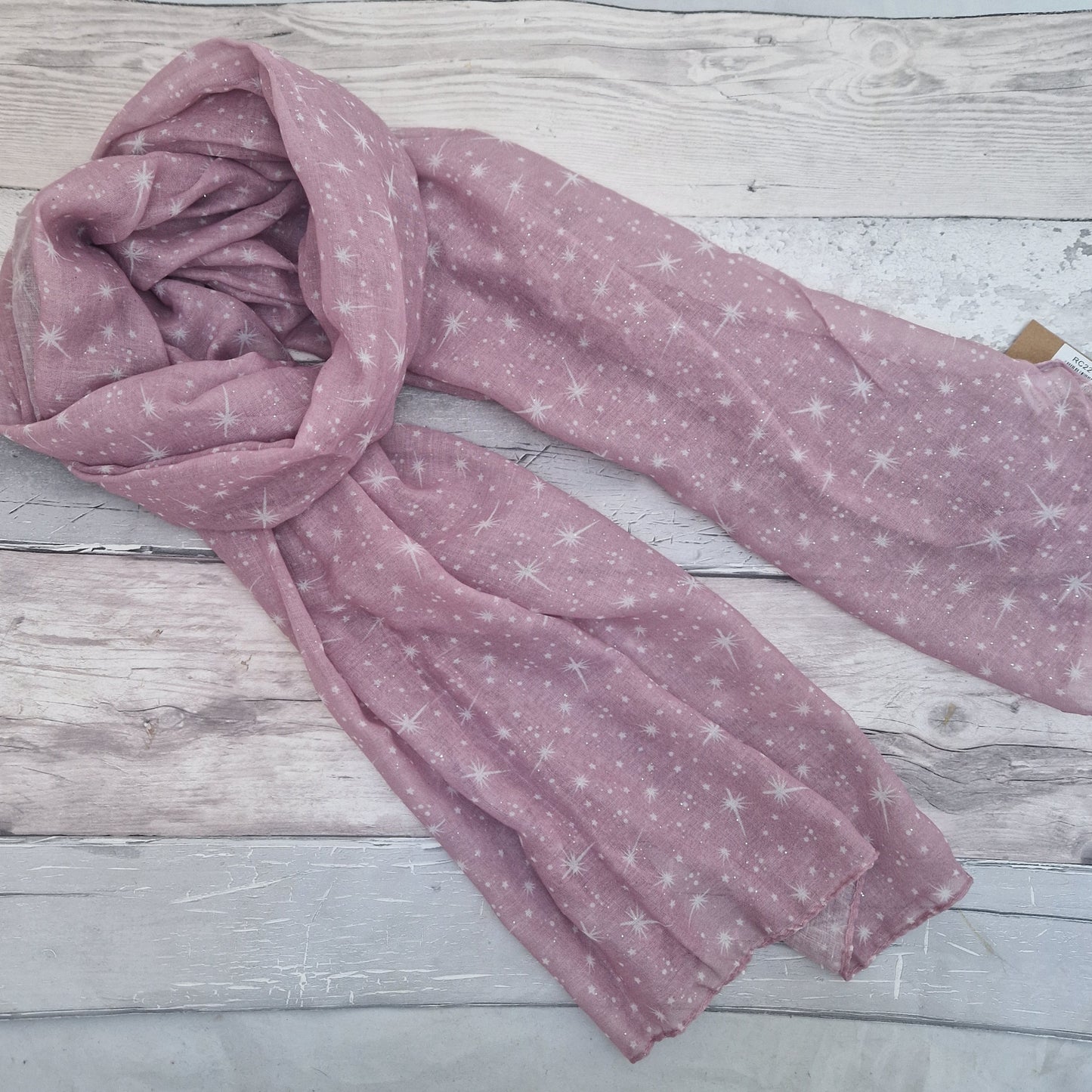 Pink Scarf covered in a star print.