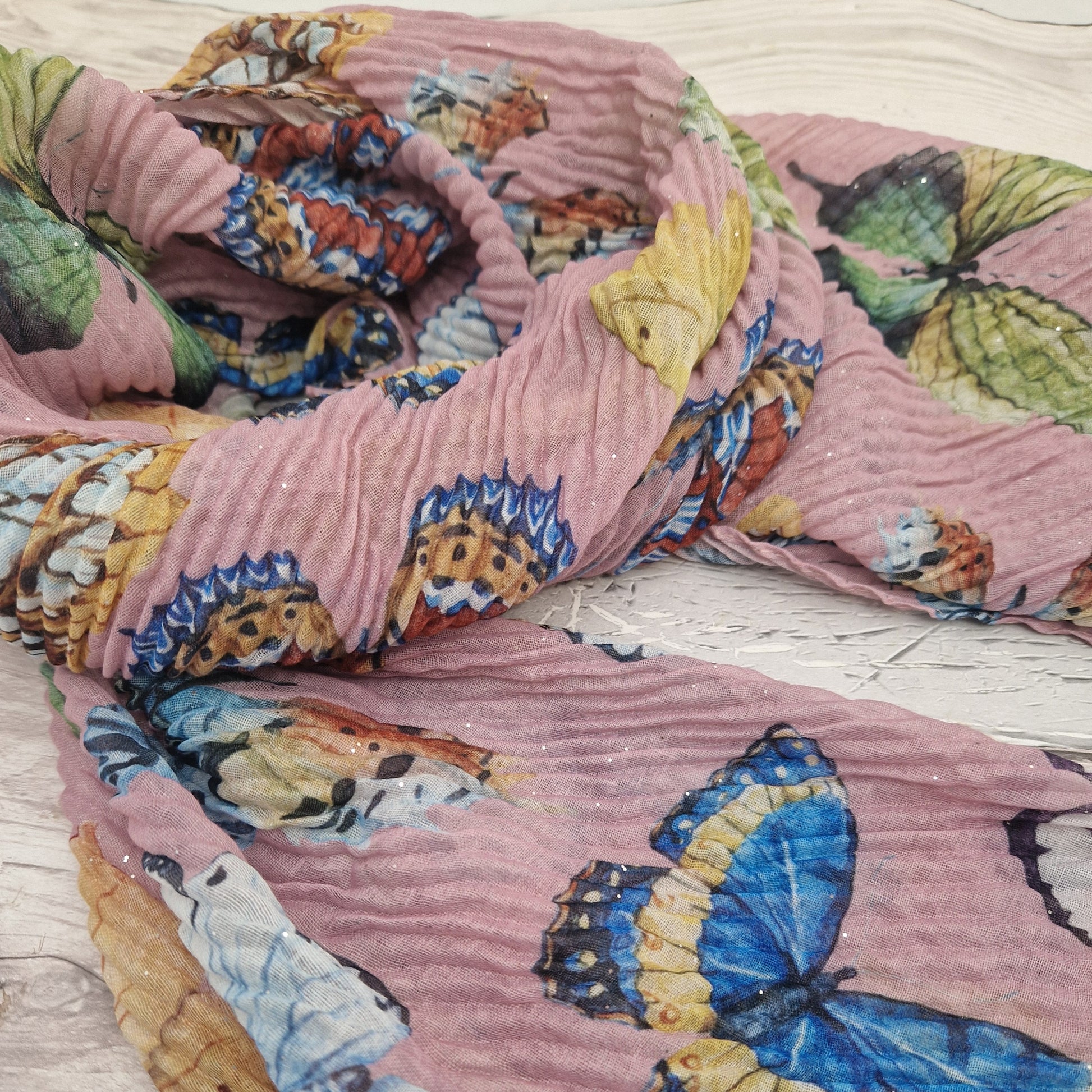 Crinkled textured scarf in Pink with very pretty collection of butterfly images in different colours.