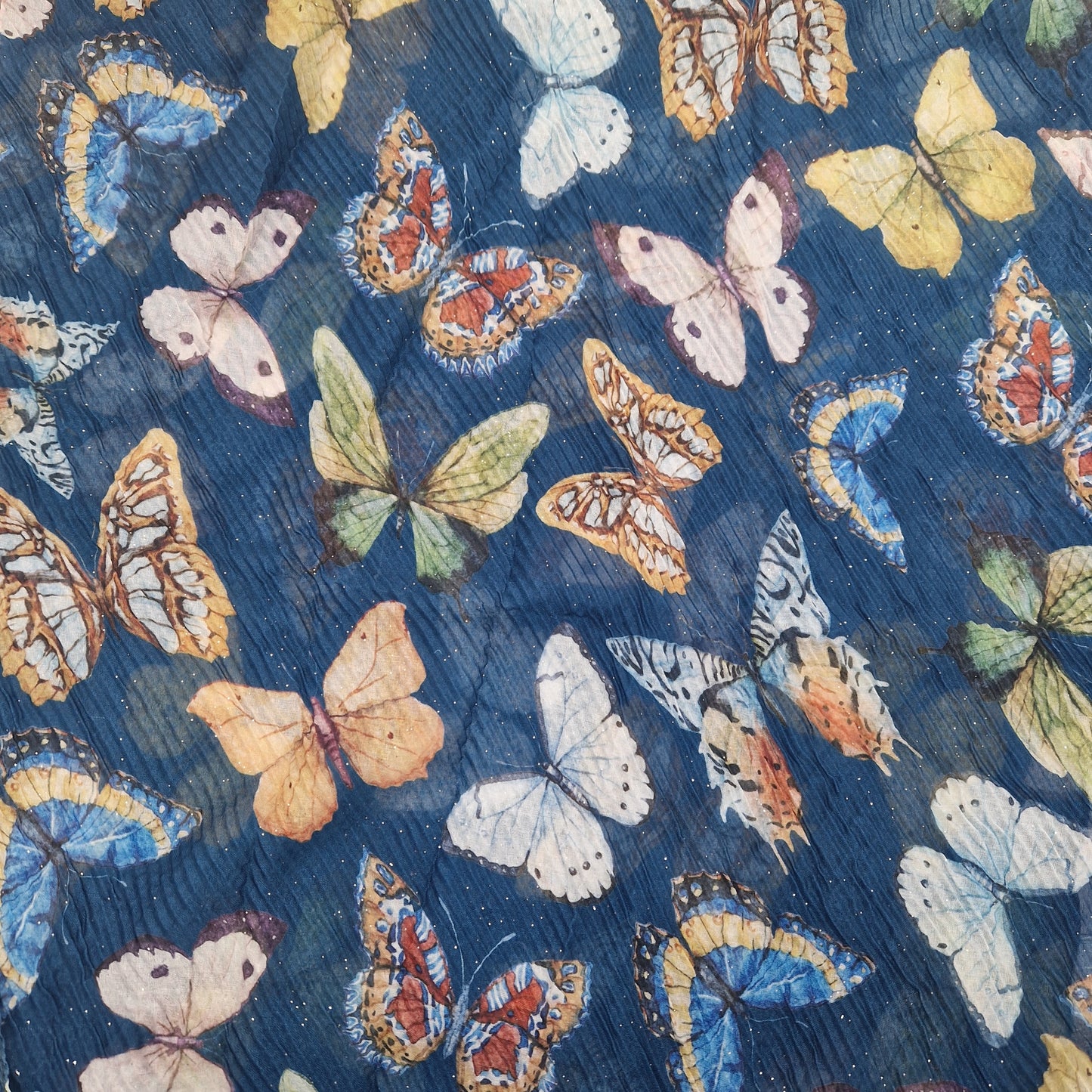 Crinkled textured scarf in blue with very pretty collection of butterfly images in different colours.