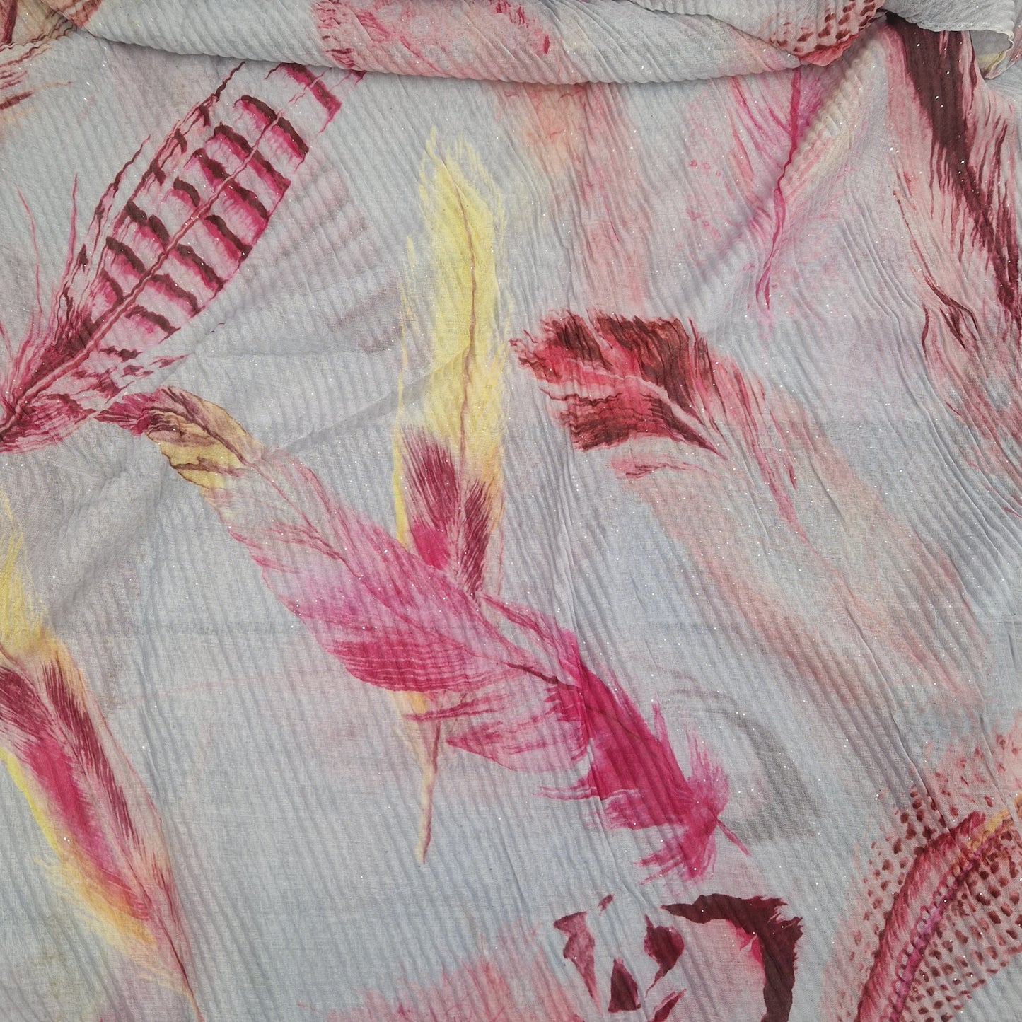 Crinkle effect pale grey scarf decorated with feathers in yellow, baby pink and hot pink.