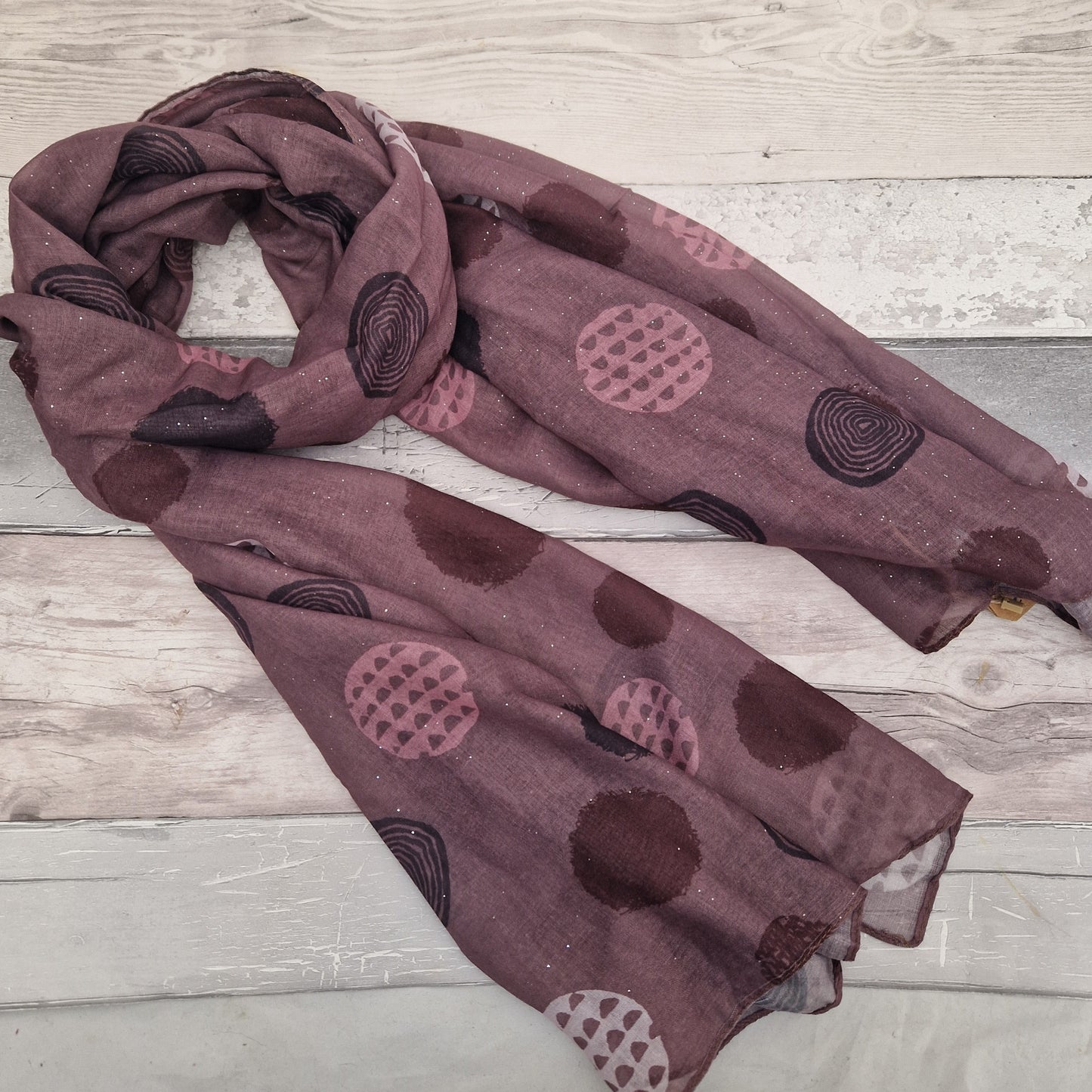 Rose Pink coloured scarf decorated with abstract circles in contrasting colours.