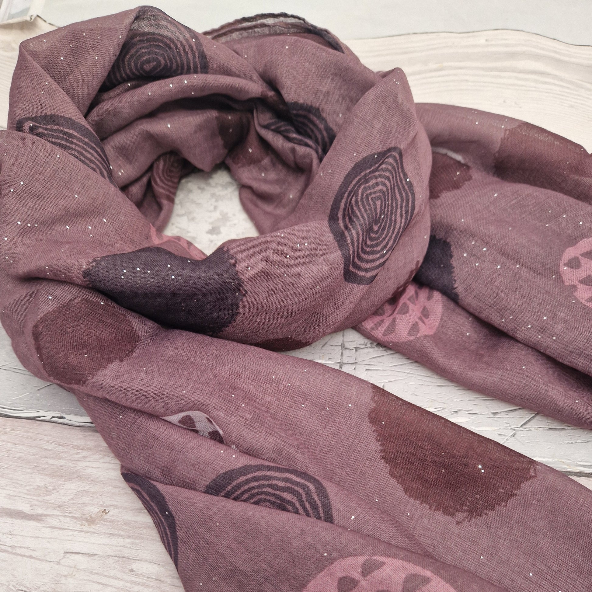 Rose Pink coloured scarf decorated with abstract circles in contrasting colours.