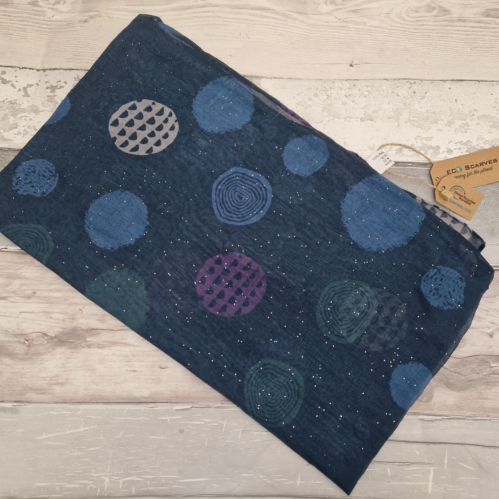 Blue coloured scarf decorated with abstract circles in contrasting colours.