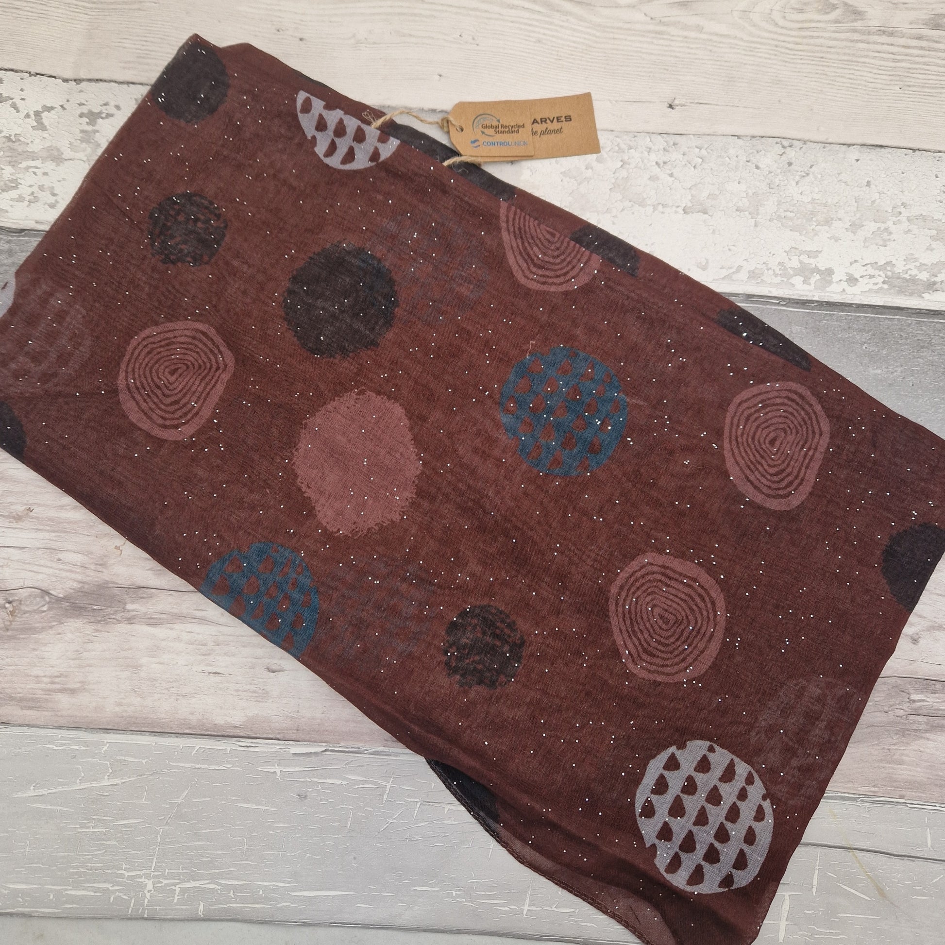 Brown coloured scarf decorated with abstract circles in contrasting colours.