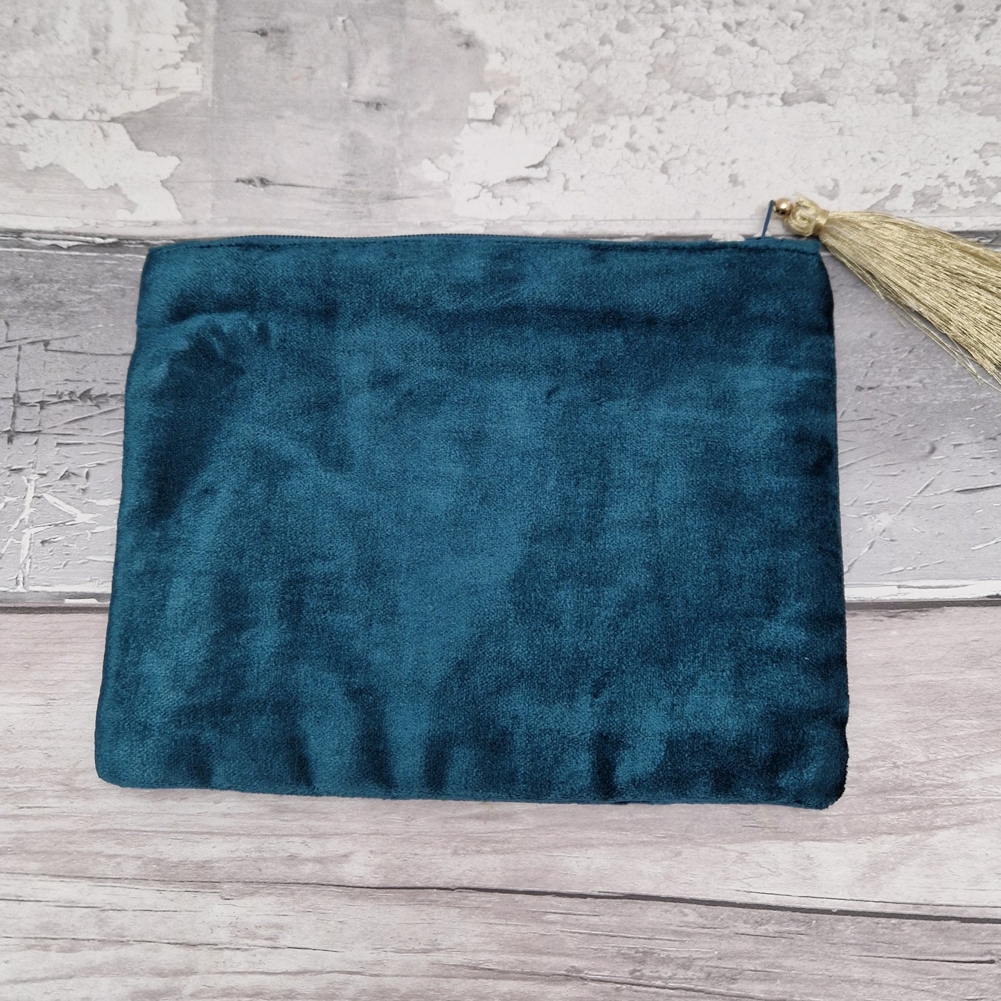 Rear view of turquoise velvet pouch.