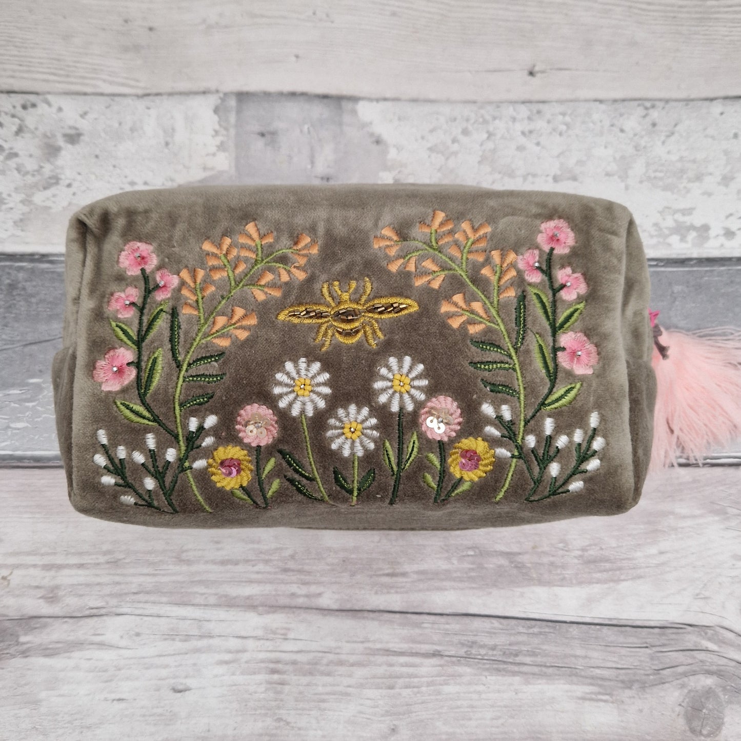 Sage coloured velvet washbag hand embroidered with sequins and beads. Depicting a flower garden with a central golden coloured bee.