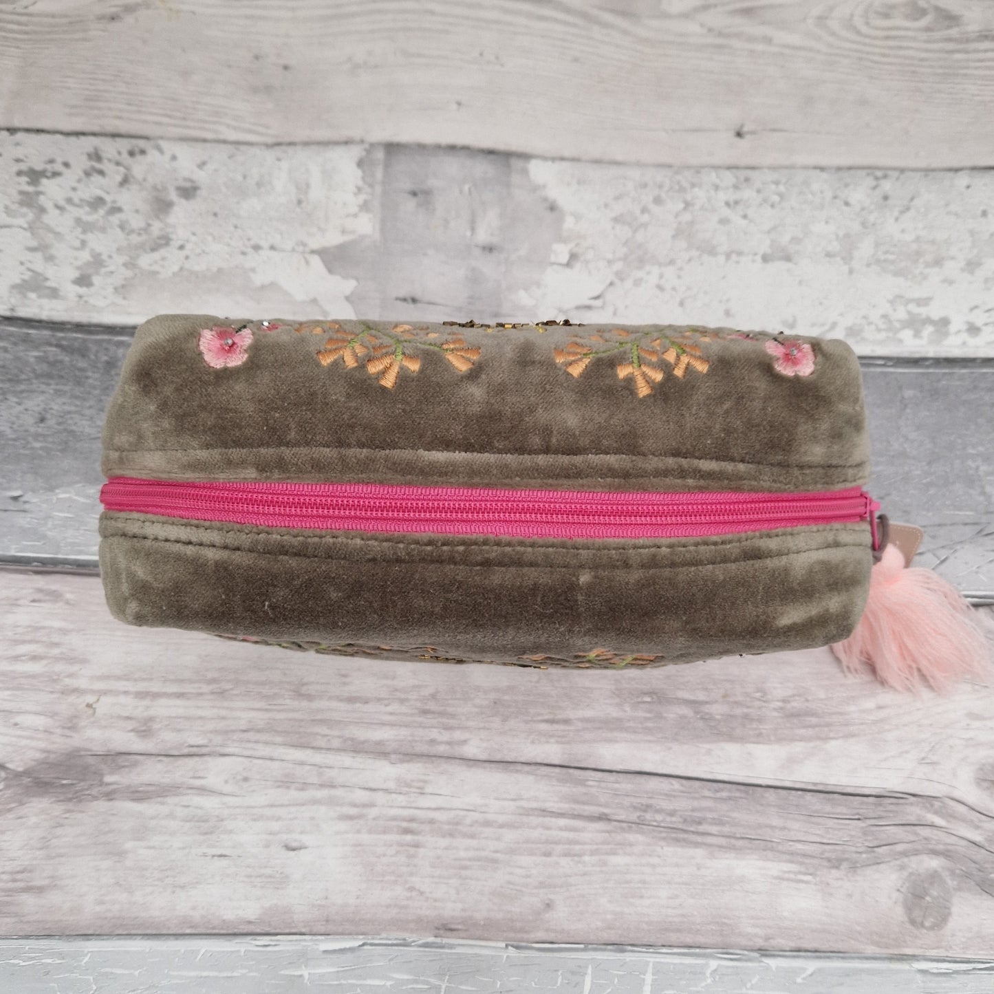 Top down view of our sage coloured velvet wash bag.